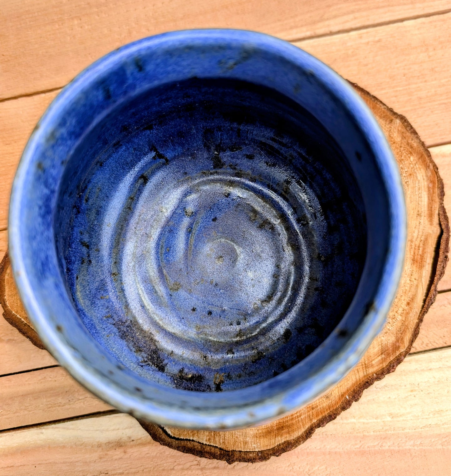 Handcrafted and artist-signed, this wheel-thrown stoneware vessel features a rich satin matte cobalt blue glaze accented with natural iron speckling. Originally created as a lidded storage jar, it now serves beautifully as a versatile open vessel for display or everyday use.