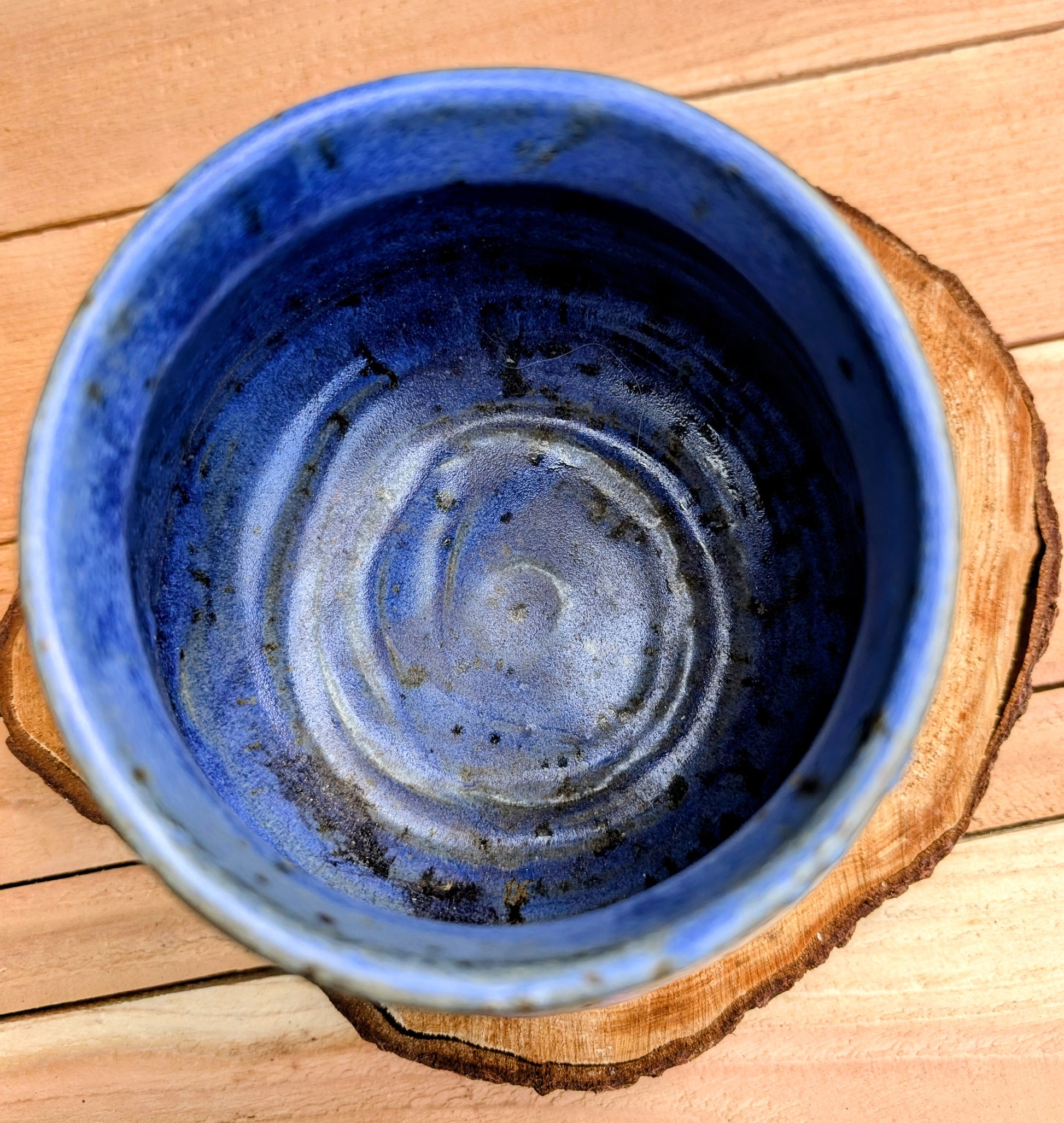 Handcrafted and artist-signed, this wheel-thrown stoneware vessel features a rich satin matte cobalt blue glaze accented with natural iron speckling. Originally created as a lidded storage jar, it now serves beautifully as a versatile open vessel for display or everyday use.