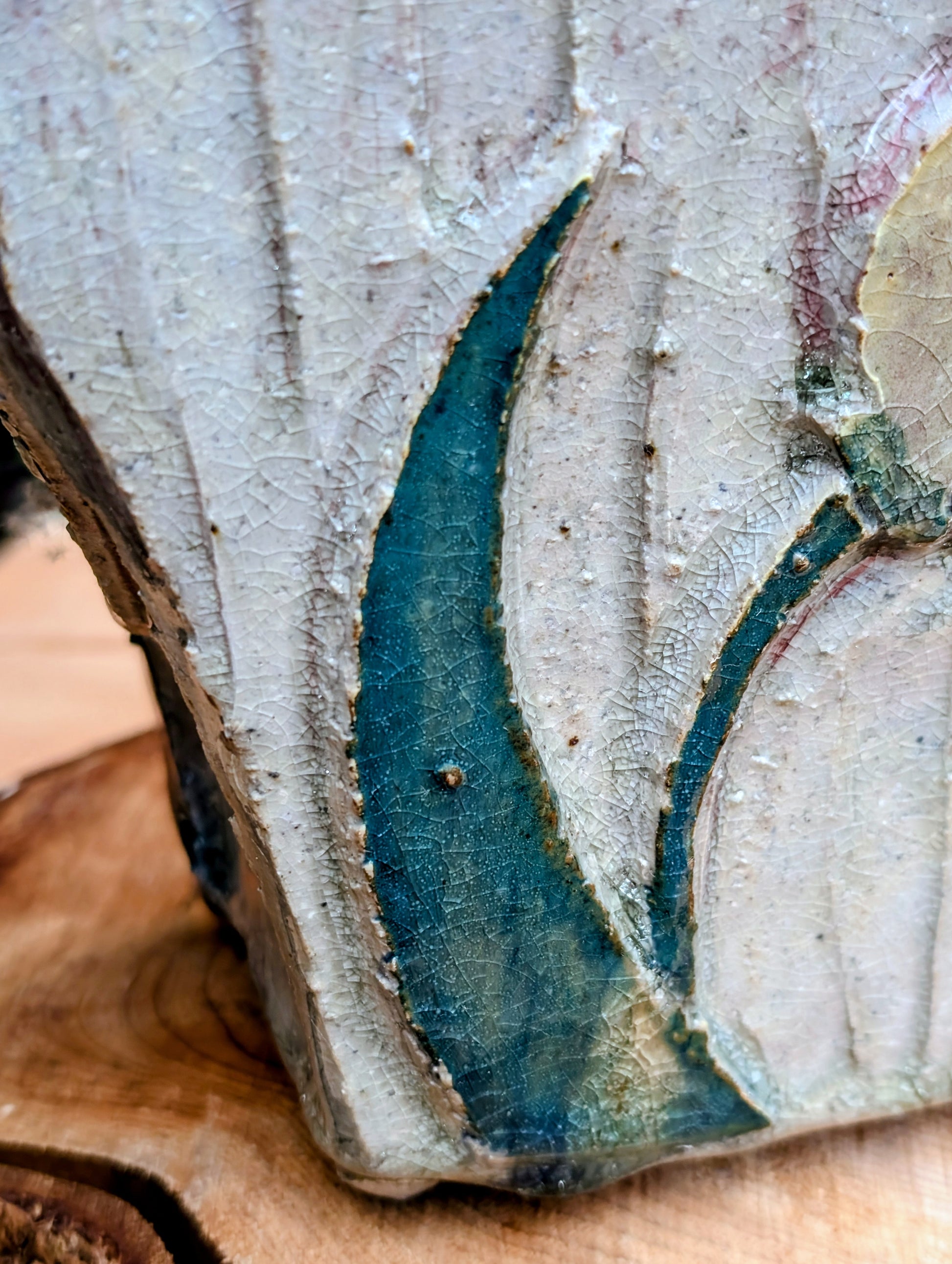Celebrate handcrafted artistry with this handbuilt stoneware vase or cachepot featuring sculpted tulip relief panels, rich matte glazes, and an architectural four-footed form. Its organic botanical design makes it equally beautiful as a floral vessel, planter, or sculptural accent.