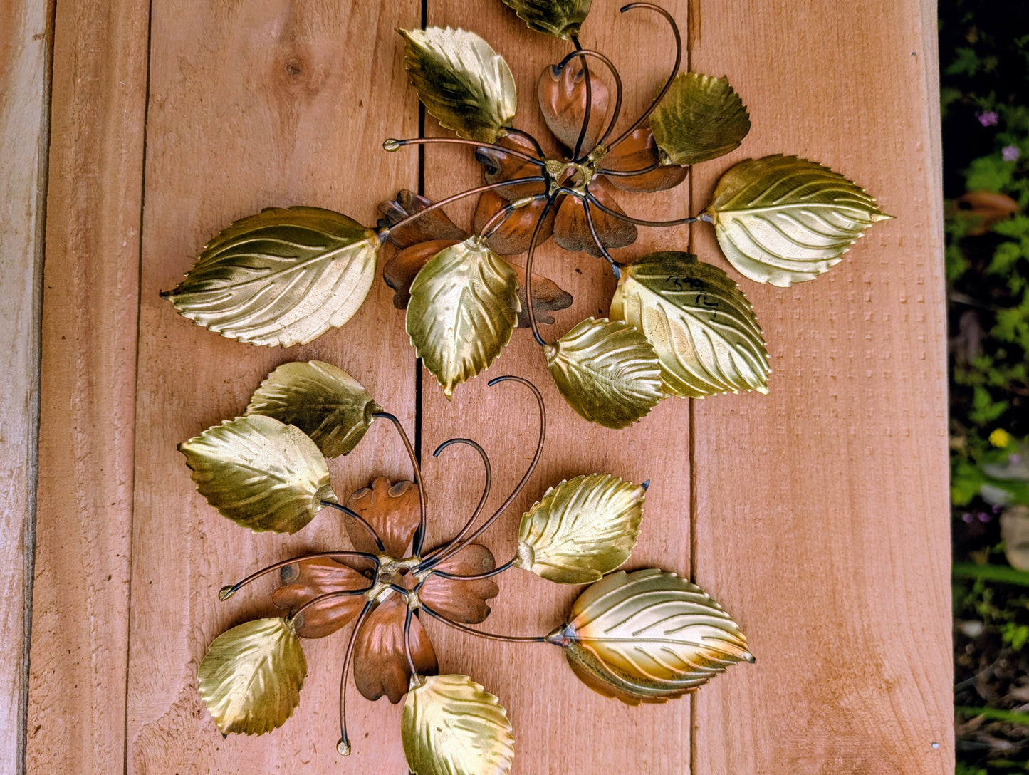 Bring the warmth of 1970s botanical décor into your home with this charming pair of vintage brass and copper-tone dogwood wall sculptures. Their delicate floral design and mixed-metal finish make them an easy addition to Mid-Century Modern, cottage, and nature-inspired interiors.