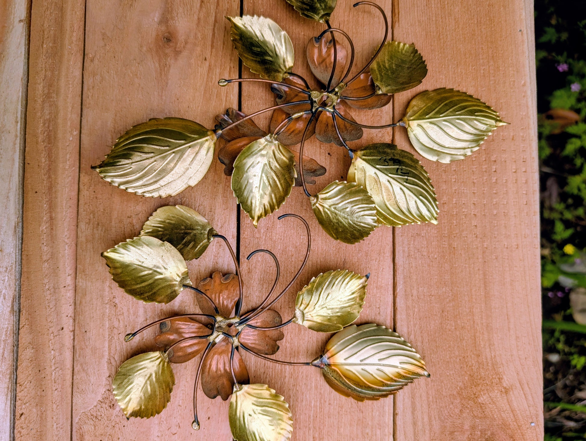 Bring the warmth of 1970s botanical décor into your home with this charming pair of vintage brass and copper-tone dogwood wall sculptures. Their delicate floral design and mixed-metal finish make them an easy addition to Mid-Century Modern, cottage, and nature-inspired interiors.