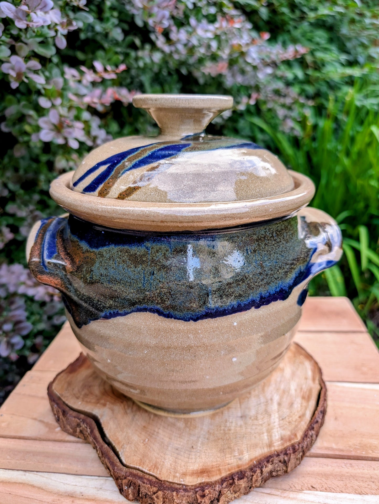 A beautifully handcrafted studio pottery tureen featuring a fitted lid, integrated handles, and a flowing cobalt blue glaze over warm oatmeal stoneware. Both functional and decorative, this artisan serving piece brings timeless craftsmanship and organic beauty to the table
