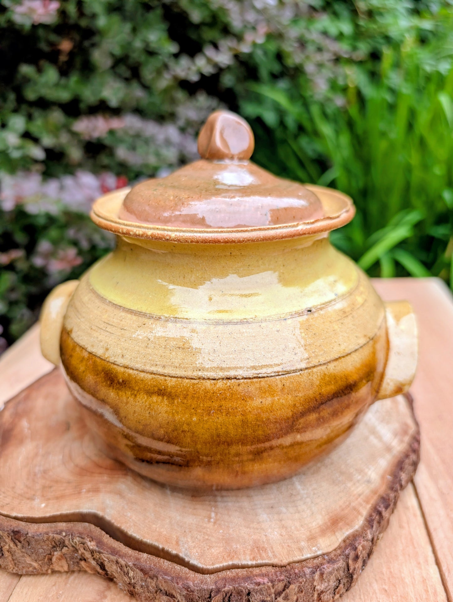 Bring timeless craftsmanship to your kitchen with this handcrafted studio pottery lidded stoneware pot. Finished in warm honey, caramel, olive, and tan glazes, this versatile covered vessel is equally beautiful as functional serveware or rustic farmhouse décor.