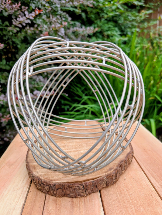 Bring sculptural simplicity to your home or garden with this stainless steel wire sphere. Its clean geometric design adds year-round visual interest, whether displayed on a tabletop, nestled among plants, or styled as a modern garden accent.