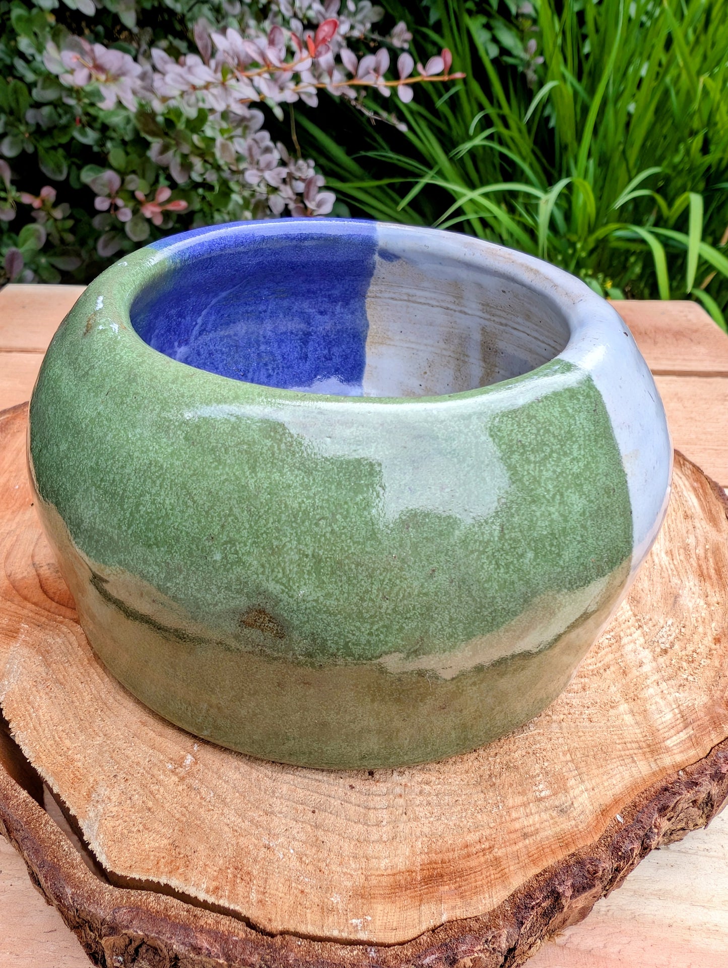 A beautifully hand-thrown studio pottery succulent planter featuring layered blue, moss green, and soft white glazes over high-fired stoneware. Complete with an integrated drainage hole and signed by the artist with the monogram "G.M.," this artisan planter brings handcrafted character to any home or garden.