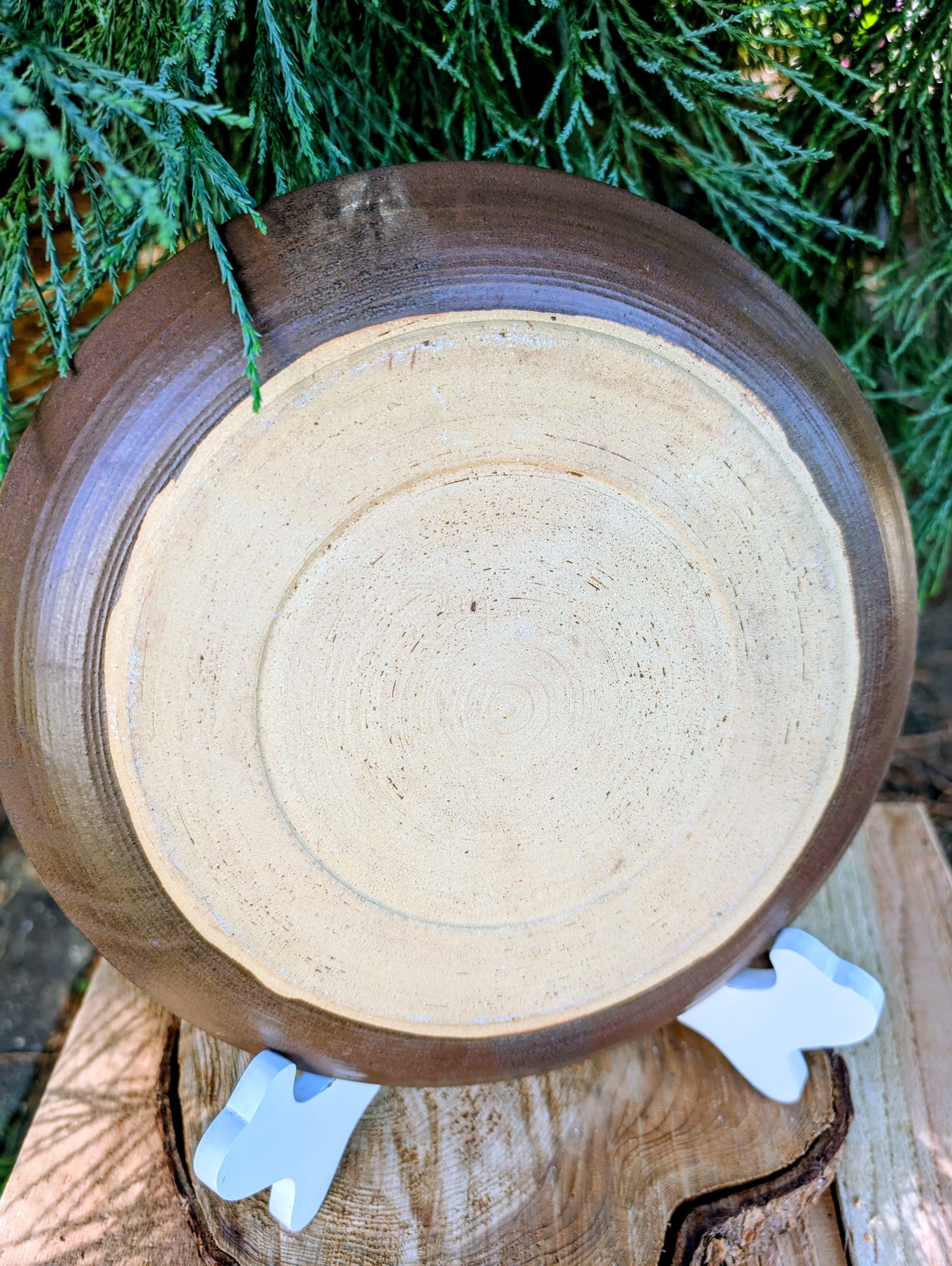 Celebrate the beauty of handmade craftsmanship with this one-of-a-kind studio pottery art plate featuring an expressive abstract octopus-inspired design. Rich earth-tone glazes and visible throwing rings make this versatile stoneware piece equally at home as functional serveware or coastal-inspired wall décor.