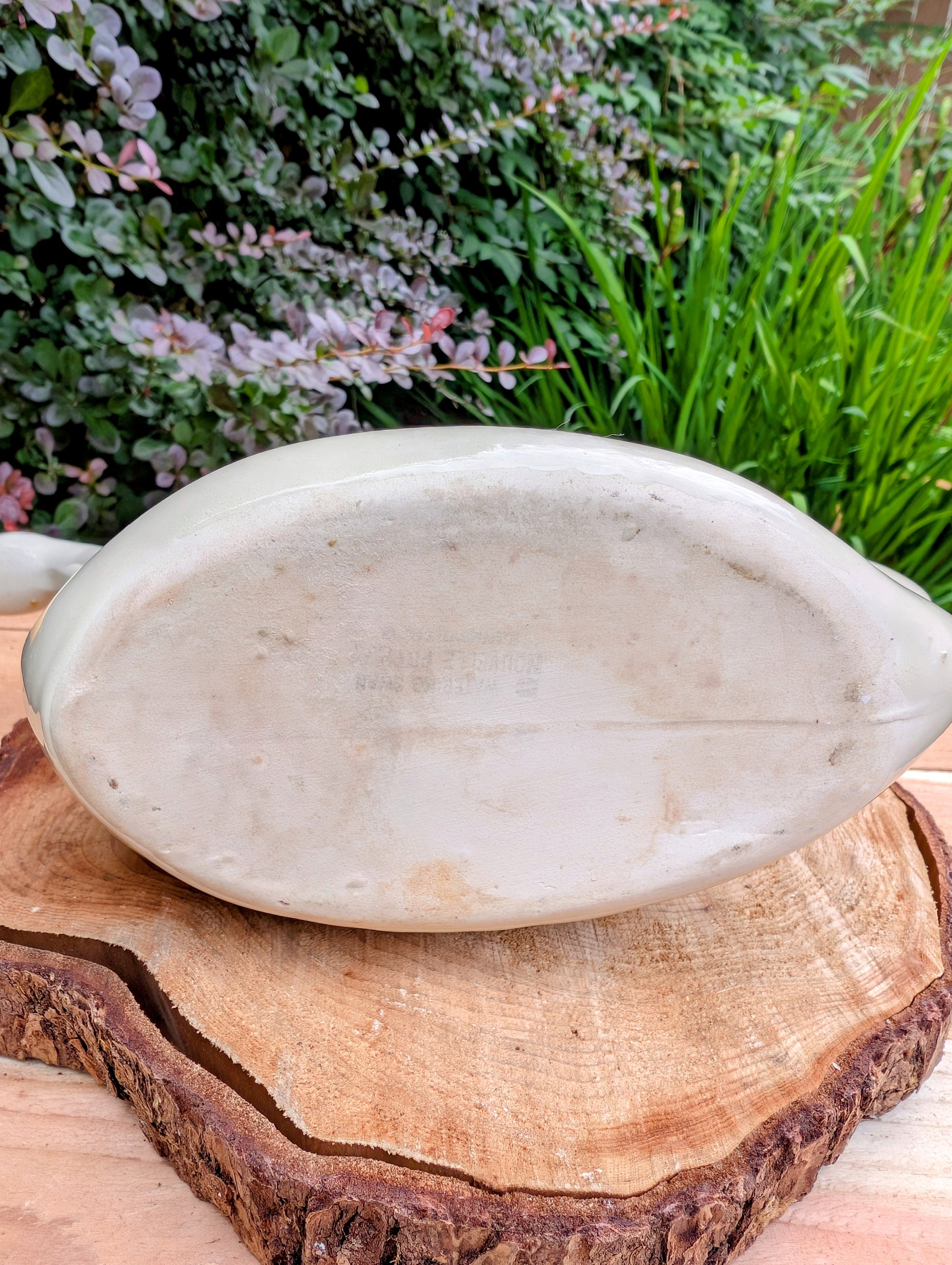 A charming 1950s Nouvelle Pottery swan watering pitcher that blends sculptural beauty with everyday function. Finished in a soft ivory glaze with hand-painted details, this Mid-Century ceramic piece is equally at home caring for houseplants or displayed as timeless vintage décor.
