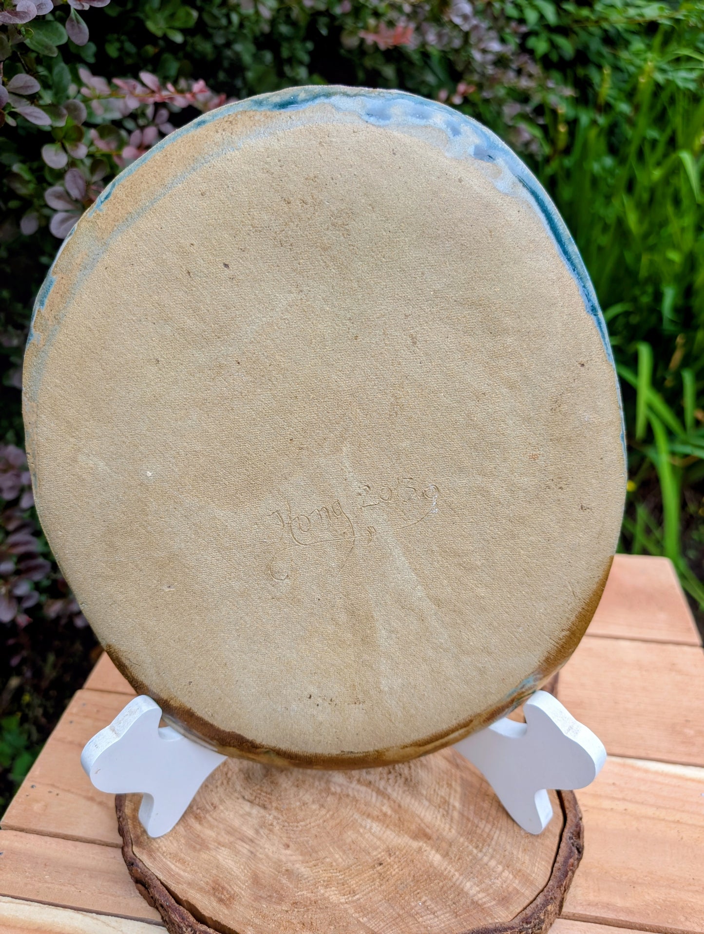 Celebrate the beauty of nature with this signed handbuilt studio pottery platter featuring an elegant botanical relief impressed directly into the clay. Finished in layered blue, teal, and olive glazes, this contemporary stoneware piece is equally at home as functional serveware or displayed as ceramic wall art.