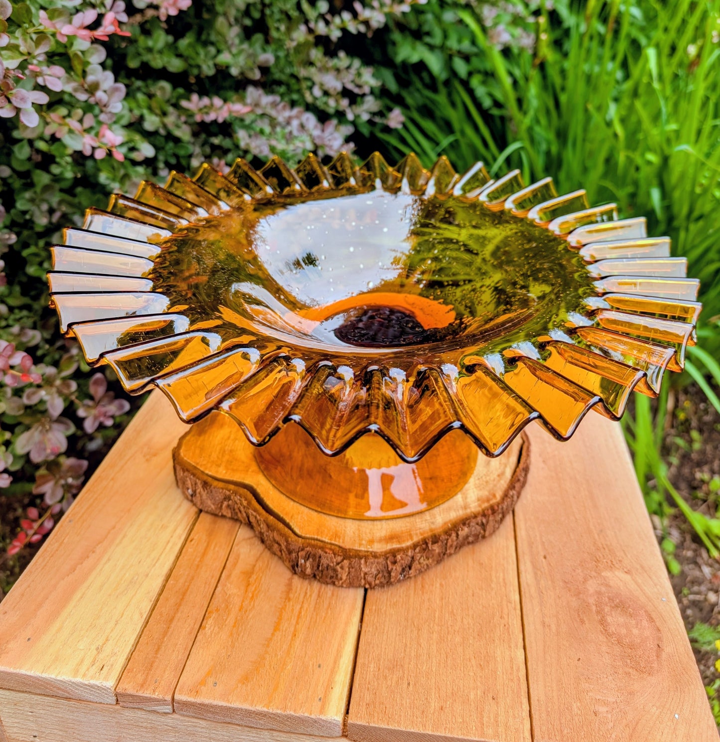 Bring warm vintage charm to your home with this large amber pressed glass pedestal console bowl, estimated to have been made by Indiana Glass during the 1960s–1970s. Its dramatic ruffled rim and generous size make it a beautiful centerpiece for seasonal displays, fruit, florals, or decorative accents throughout the year.