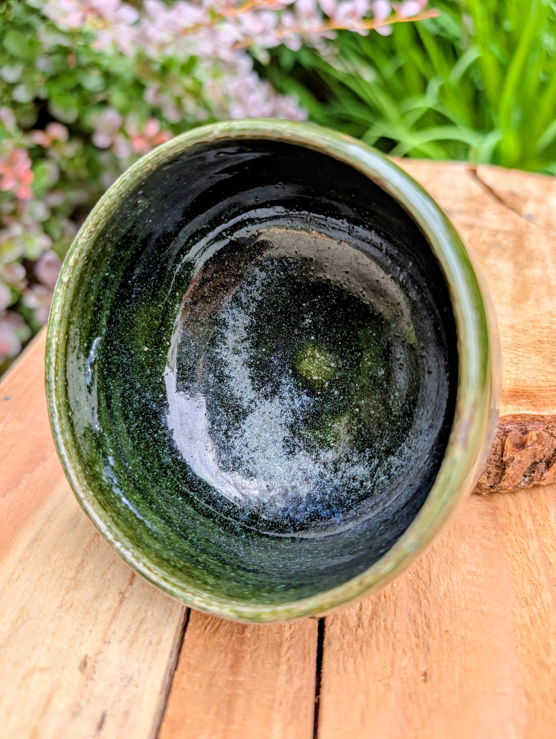 A beautifully hand-thrown studio pottery bowl featuring a rich olive green interior and layered blue, cream, and earthy brown glaze. Signed by the artist, this compact stoneware piece blends functional craftsmanship with timeless Pacific Northwest style.