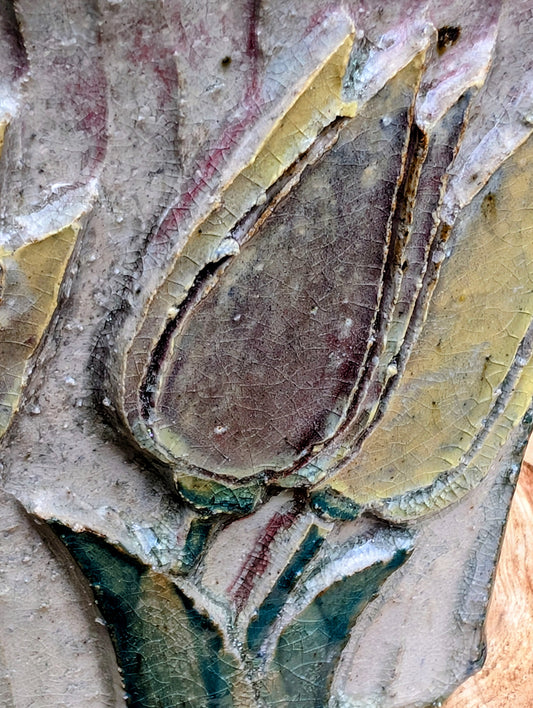 Celebrate handcrafted artistry with this handbuilt stoneware vase or cachepot featuring sculpted tulip relief panels, rich matte glazes, and an architectural four-footed form. Its organic botanical design makes it equally beautiful as a floral vessel, planter, or sculptural accent.