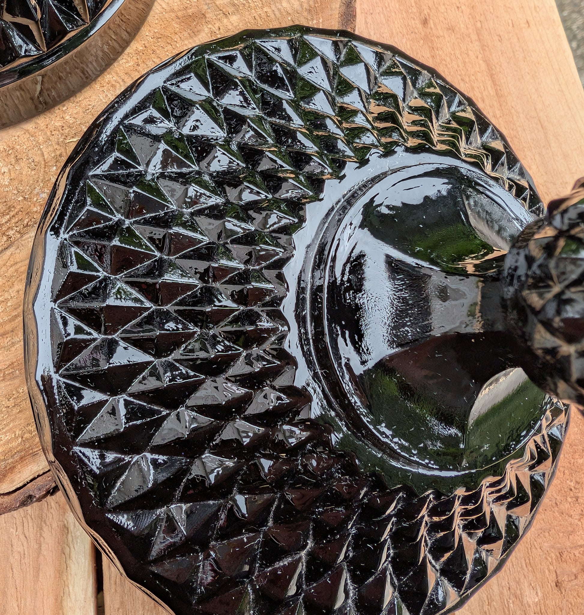 Make a dramatic statement with this vintage Tiara Exclusives Diamond Point covered pedestal compote in rich Cameo Black glass. Standing an impressive 16 inches tall, this elegant pressed glass piece is perfect for displaying wrapped candies, seasonal décor, ornaments, or treasured collectibles throughout the year.