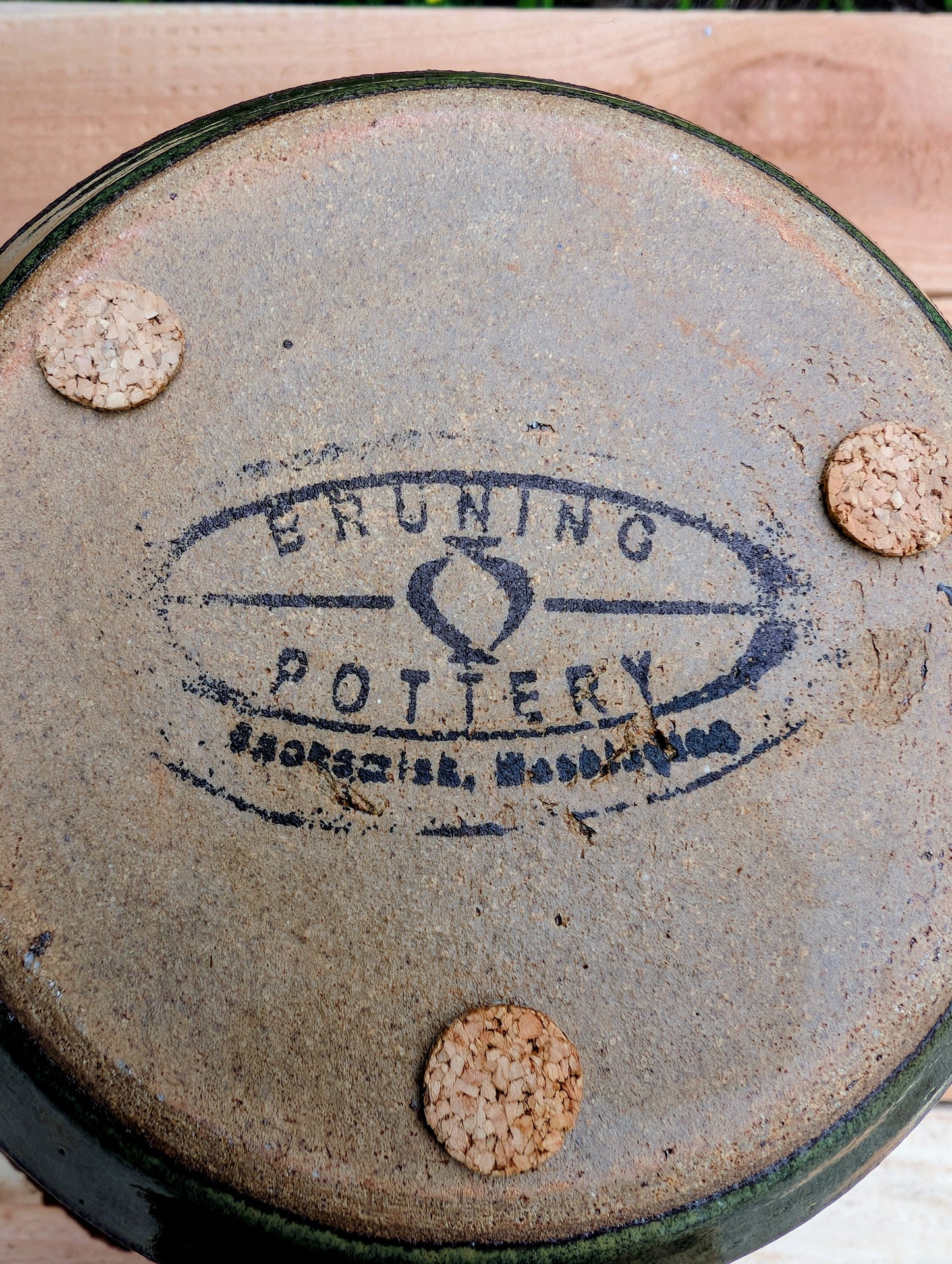 Handcrafted in Snohomish, Washington, this authentic Bruning Pottery stoneware planter showcases flowing moss green, olive, brown, and plum glazes inspired by the Pacific Northwest landscape. Complete with an integrated saucer, it's a beautiful and functional piece for houseplants, herbs, or succulent collections.