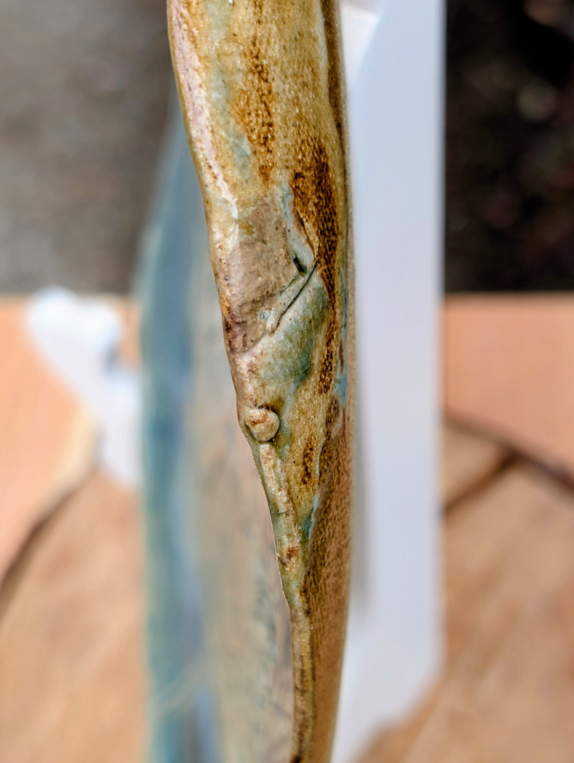 Celebrate the beauty of nature with this signed handbuilt studio pottery platter featuring an elegant botanical relief impressed directly into the clay. Finished in layered blue, teal, and olive glazes, this contemporary stoneware piece is equally at home as functional serveware or displayed as ceramic wall art.