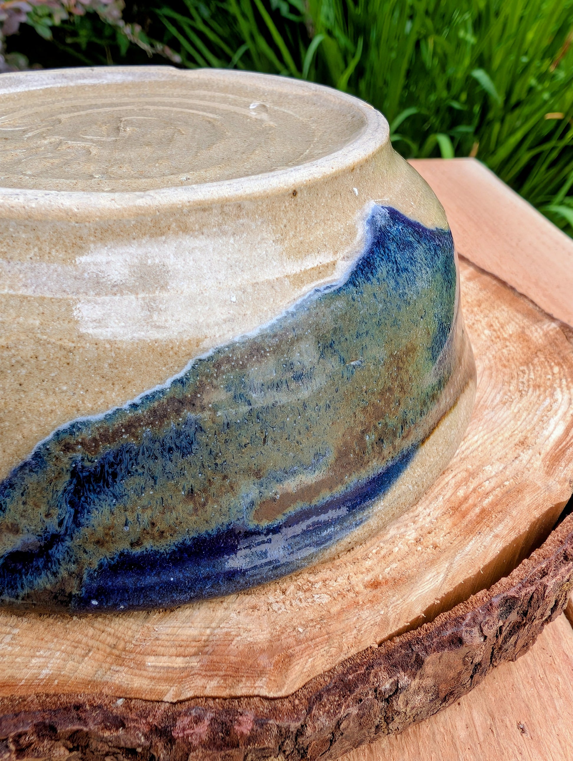 Bring handcrafted warmth to your table with this beautifully wheel-thrown studio pottery bowl, attributed to Gladstone Wear. Featuring flowing cobalt blue, charcoal, and earthy brown glazes over a natural buff stoneware body, it offers timeless artisan appeal for serving or display.
