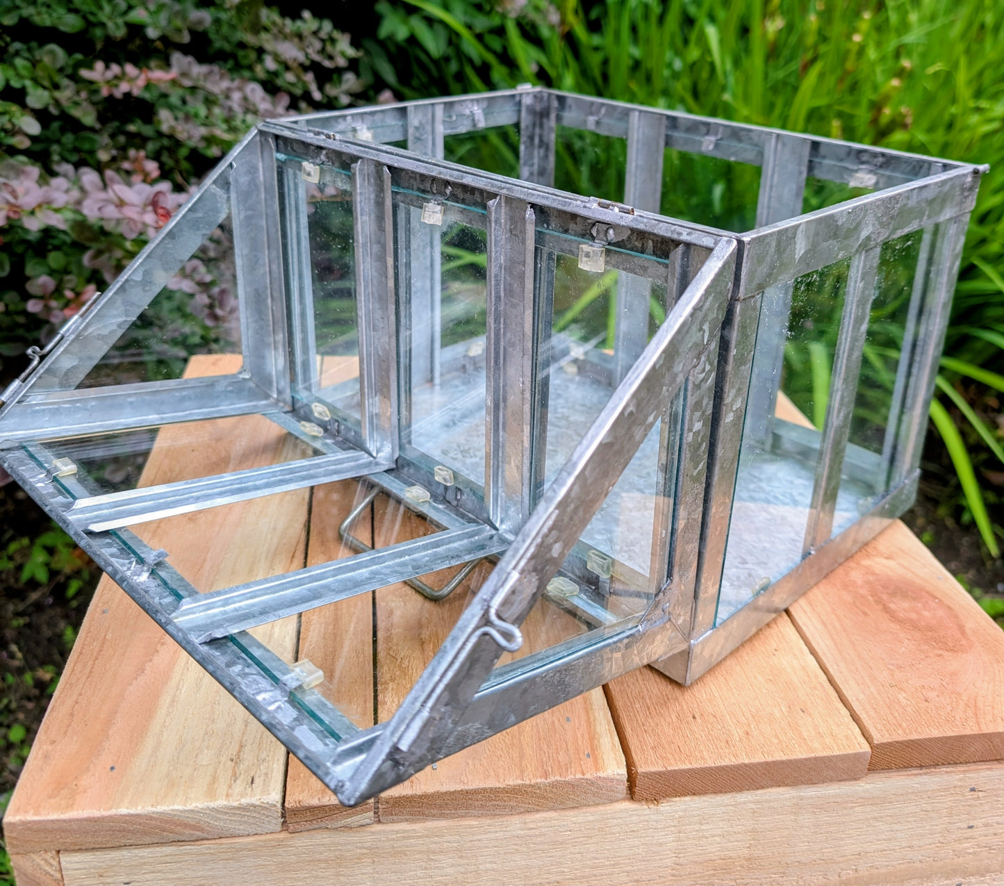 Bring the charm of a Victorian conservatory indoors with this decorative galvanized metal and glass tabletop greenhouse. Perfect for displaying succulents, moss gardens, candles, seasonal décor, or treasured collectibles, it adds timeless botanical style to any room.