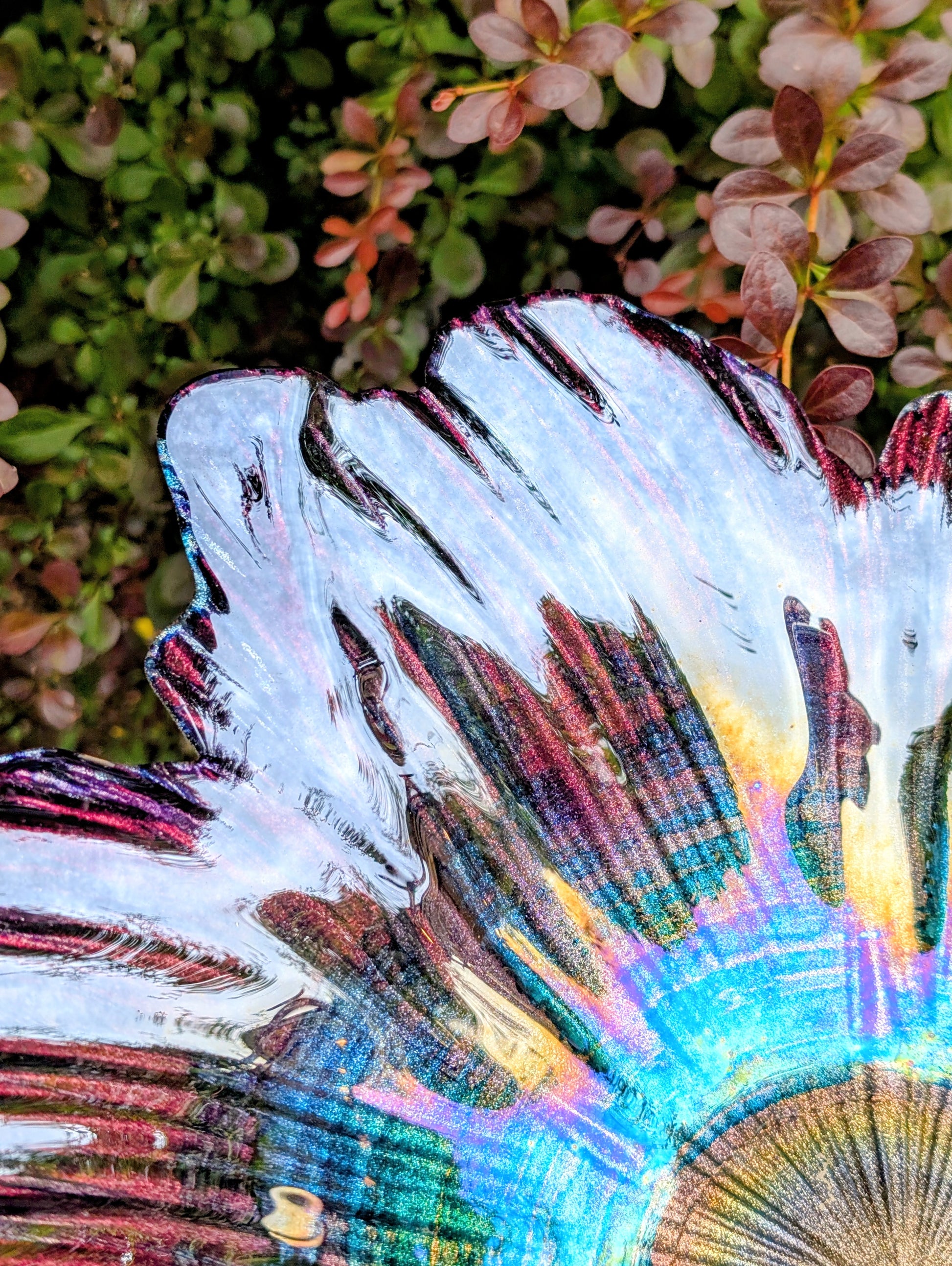 Bring color and artistry to your home or garden with this iridescent art glass floral bowl. Featuring shimmering purple and blue hues, it serves beautifully as either a striking tabletop centerpiece or a decorative bird bath bowl.