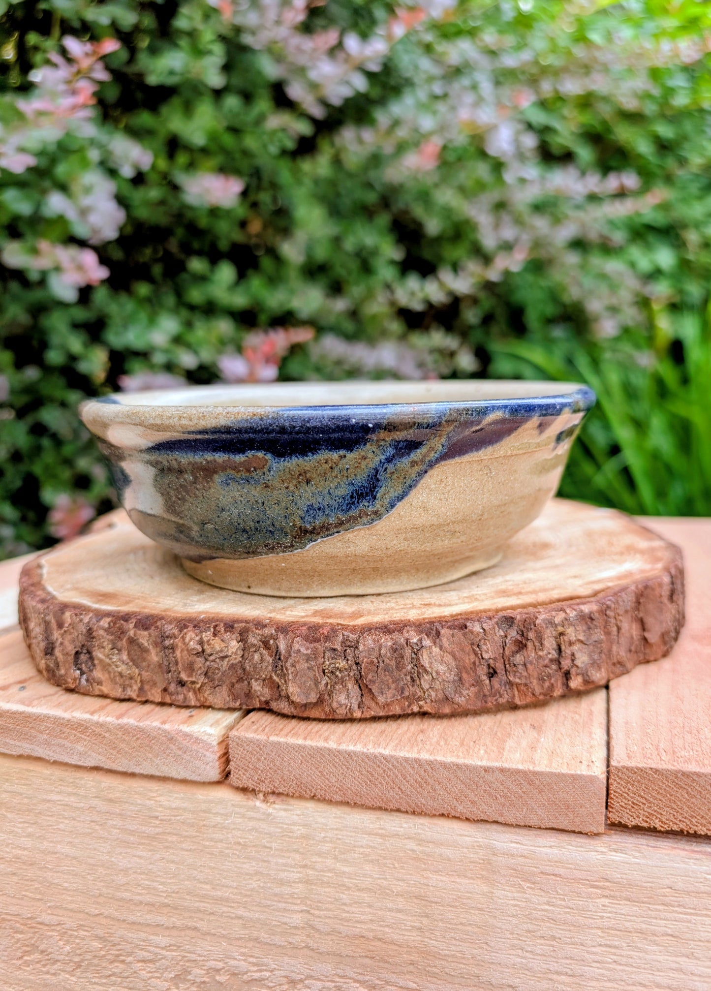 Bring handcrafted warmth to your table with this beautifully wheel-thrown studio pottery bowl, attributed to Gladstone Wear. Featuring flowing cobalt blue, charcoal, and earthy brown glazes over a natural buff stoneware body, it offers timeless artisan appeal for serving or display.