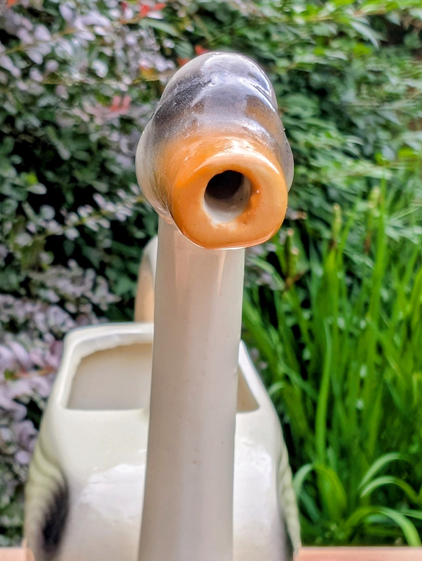 A charming 1950s Nouvelle Pottery swan watering pitcher that blends sculptural beauty with everyday function. Finished in a soft ivory glaze with hand-painted details, this Mid-Century ceramic piece is equally at home caring for houseplants or displayed as timeless vintage décor.