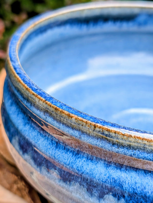 A beautifully hand-thrown studio pottery bowl dated 1990, featuring a rich satin cobalt blue glaze with a subtle spiral movement across the interior. Signed by the artist (maker currently unconfirmed), this functional stoneware piece blends everyday usefulness with timeless handcrafted artistry.