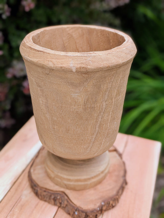 Bring natural warmth and organic texture into your home with this hand-carved paulownia wood footed vase. Its sculptural silhouette and unfinished wood grain make it a timeless accent for dried botanicals, seasonal branches, or as a beautiful standalone decorative piece.