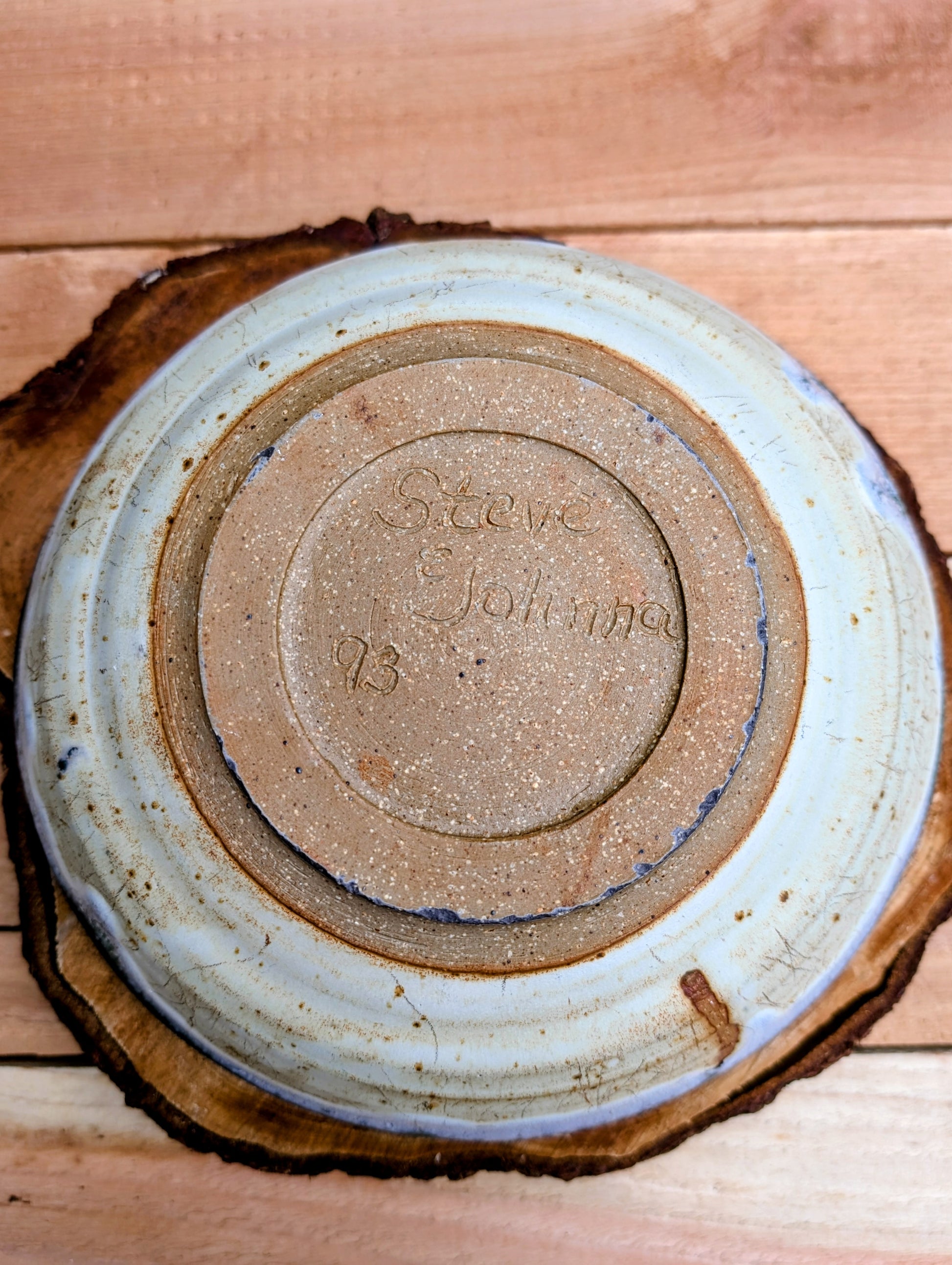 A beautifully handcrafted studio pottery bowl signed by Steve & Johnna and dated 1993. Featuring layered forest green, lavender-blue, and cream glazes, this wheel-thrown stoneware piece embodies the timeless beauty of American studio ceramics and is equally suited for everyday use or display.