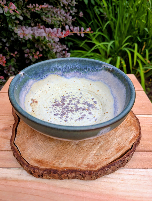 A beautifully handcrafted studio pottery bowl signed by Steve & Johnna and dated 1993. Featuring layered forest green, lavender-blue, and cream glazes, this wheel-thrown stoneware piece embodies the timeless beauty of American studio ceramics and is equally suited for everyday use or display.