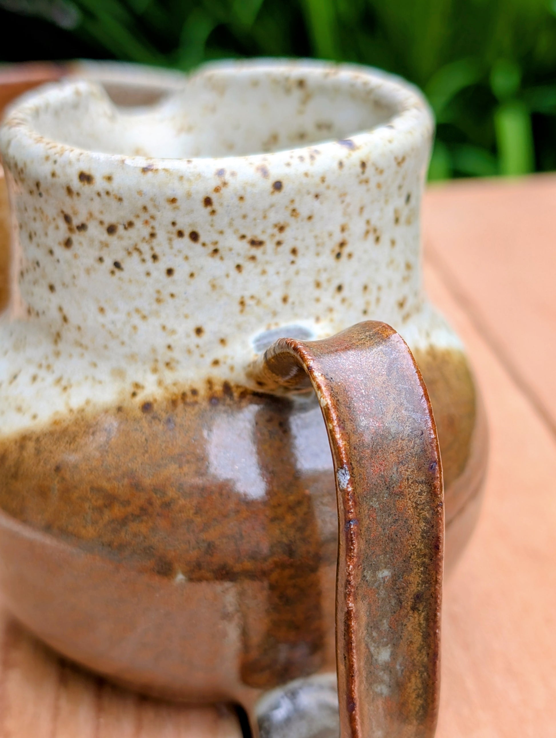 Bring handcrafted warmth to your table with this signed studio pottery creamer and sugar bowl set. Finished in a beautiful speckled cream glaze with flowing olive-brown accents, this artisan stoneware pair blends rustic craftsmanship with timeless everyday function.