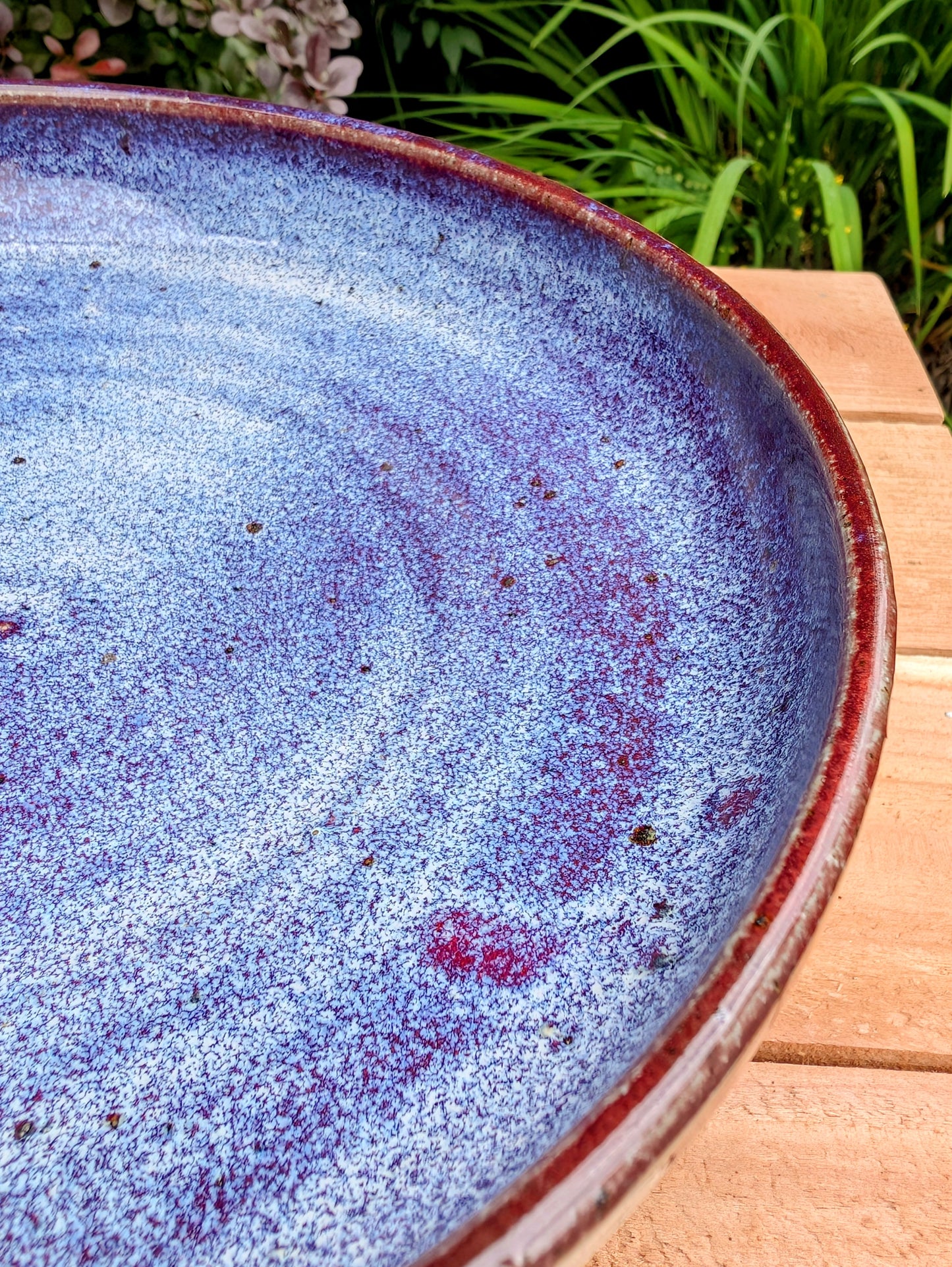 A beautifully hand-thrown studio pottery serving bowl signed and dated 1991, featuring a richly layered cobalt blue interior and deep oxblood exterior glaze. Whether used for serving or displayed as functional art, this handcrafted stoneware piece showcases the timeless beauty of American studio ceramics.