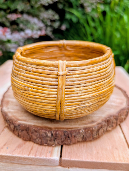 Bring warmth and natural texture to your home with this handwoven vintage rattan cachepot. Perfect for displaying a small plant, organizing everyday essentials, or adding an organic touch to a shelf or tabletop, this timeless basket complements coastal, cottage, and Pacific Northwest-inspired interiors.