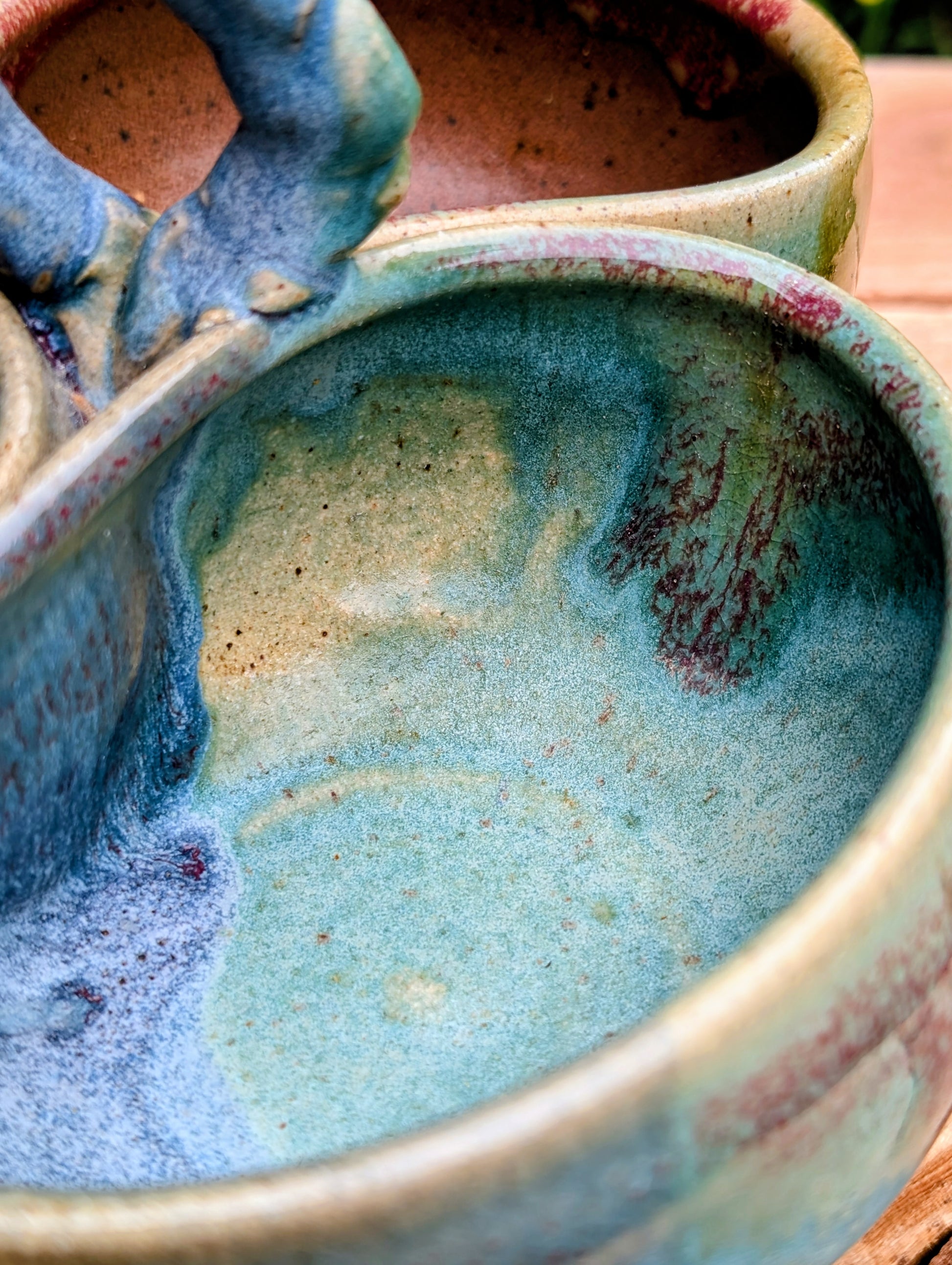Beautifully handcrafted and artist signed, this three-bowl stoneware condiment server combines sculptural artistry with everyday functionality. Finished in layered seafoam, aqua, moss, and earthy glazes, it brings timeless craftsmanship and Pacific Northwest-inspired beauty to entertaining.