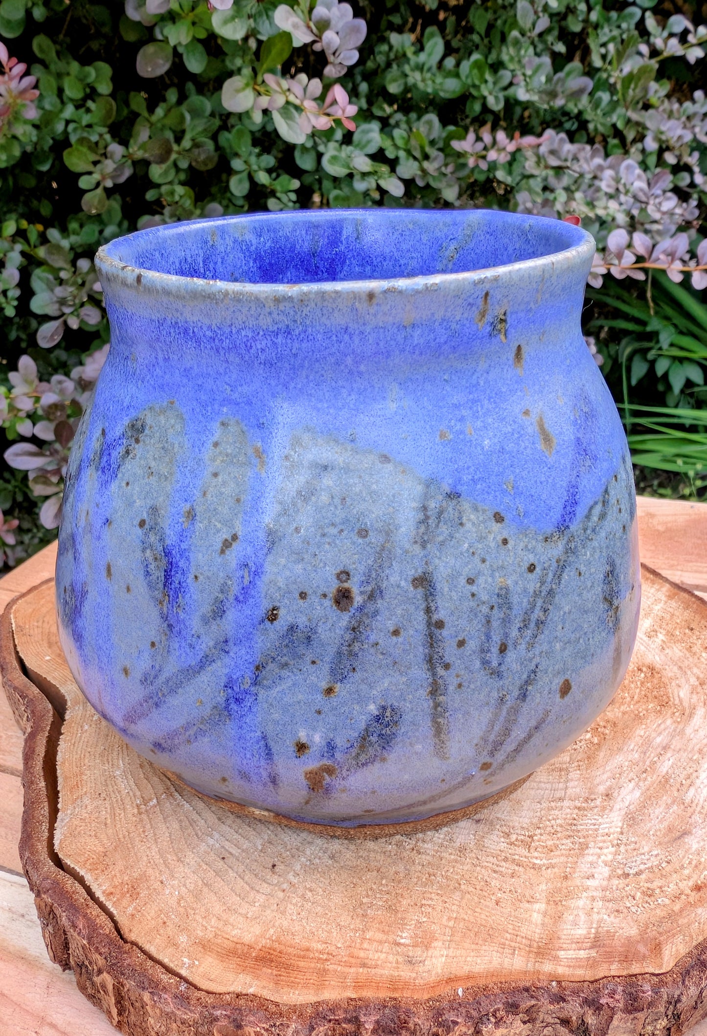 Handcrafted and artist-signed, this wheel-thrown stoneware vessel features a rich satin matte cobalt blue glaze accented with natural iron speckling. Originally created as a lidded storage jar, it now serves beautifully as a versatile open vessel for display or everyday use.