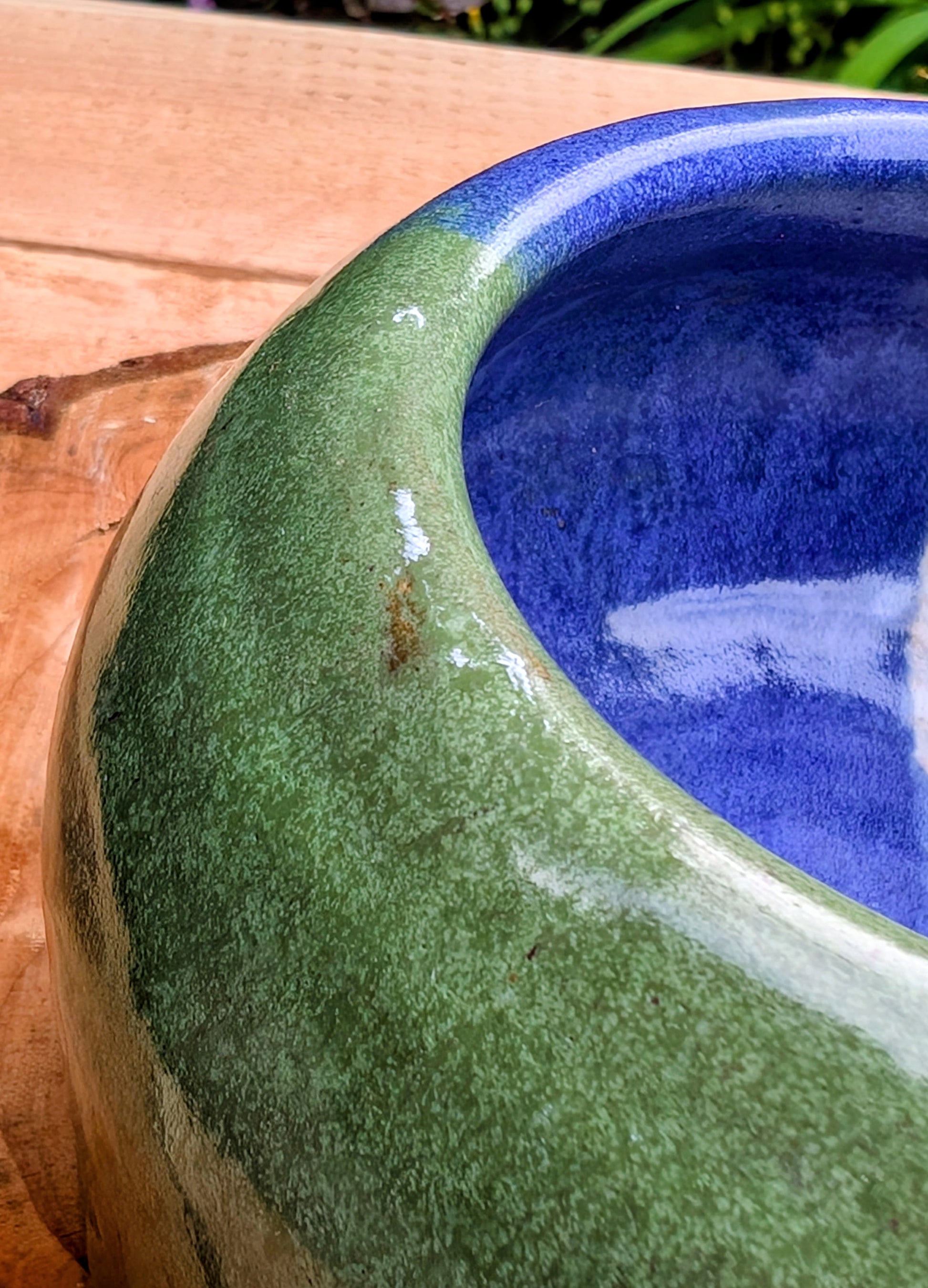 A beautifully hand-thrown studio pottery succulent planter featuring layered blue, moss green, and soft white glazes over high-fired stoneware. Complete with an integrated drainage hole and signed by the artist with the monogram "G.M.," this artisan planter brings handcrafted character to any home or garden.