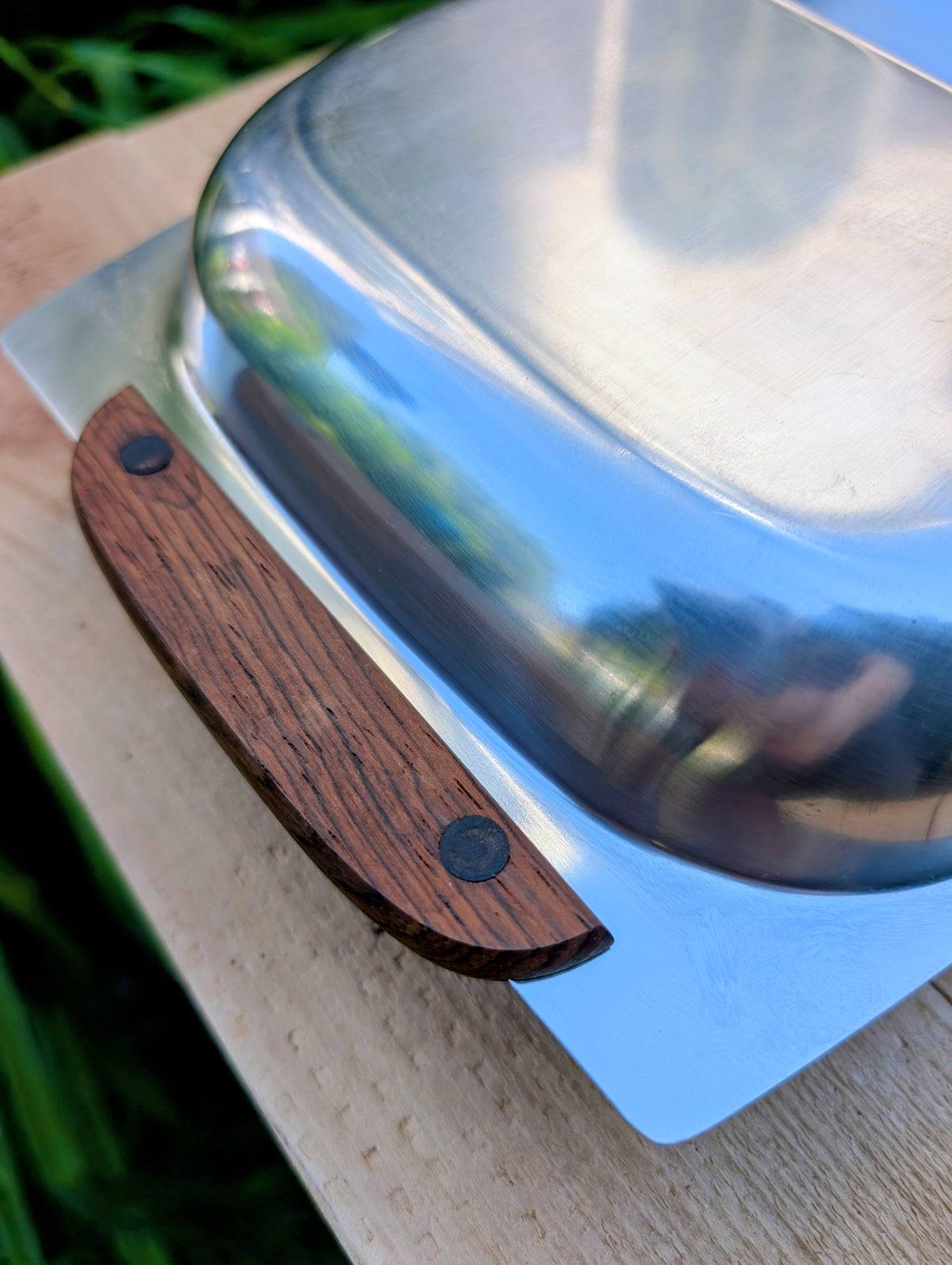 Invite a greater variety of backyard birds to your garden with this repurposed vintage stainless steel divided serving tray. Featuring two feeding compartments and warm wood handles, this one-of-a-kind piece combines timeless vintage style with practical bird-friendly function.