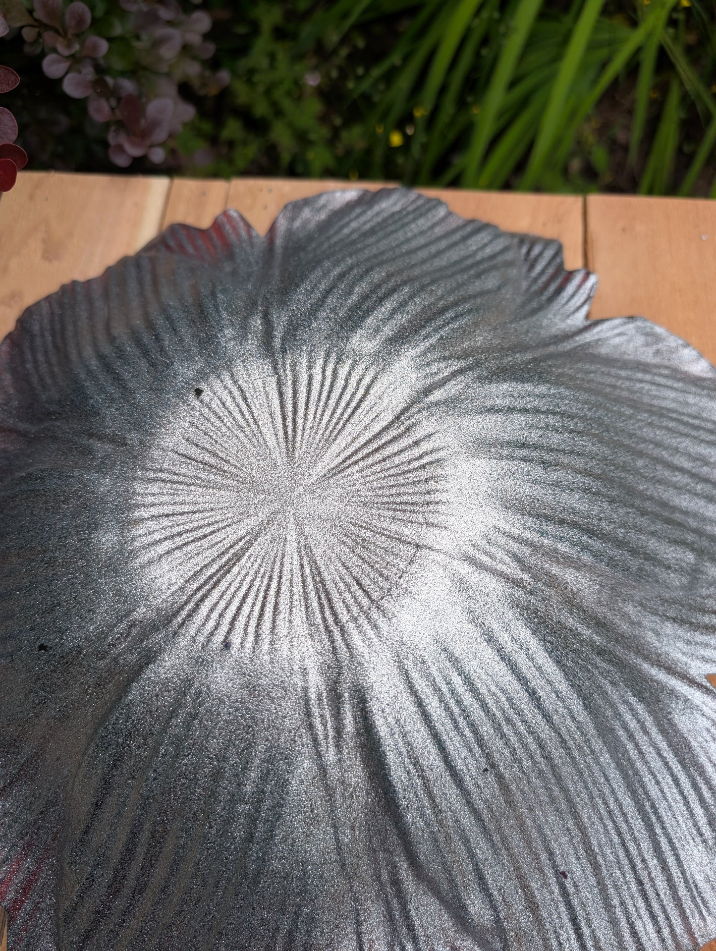 Bring color and artistry to your home or garden with this iridescent art glass floral bowl. Featuring shimmering purple and blue hues, it serves beautifully as either a striking tabletop centerpiece or a decorative bird bath bowl.