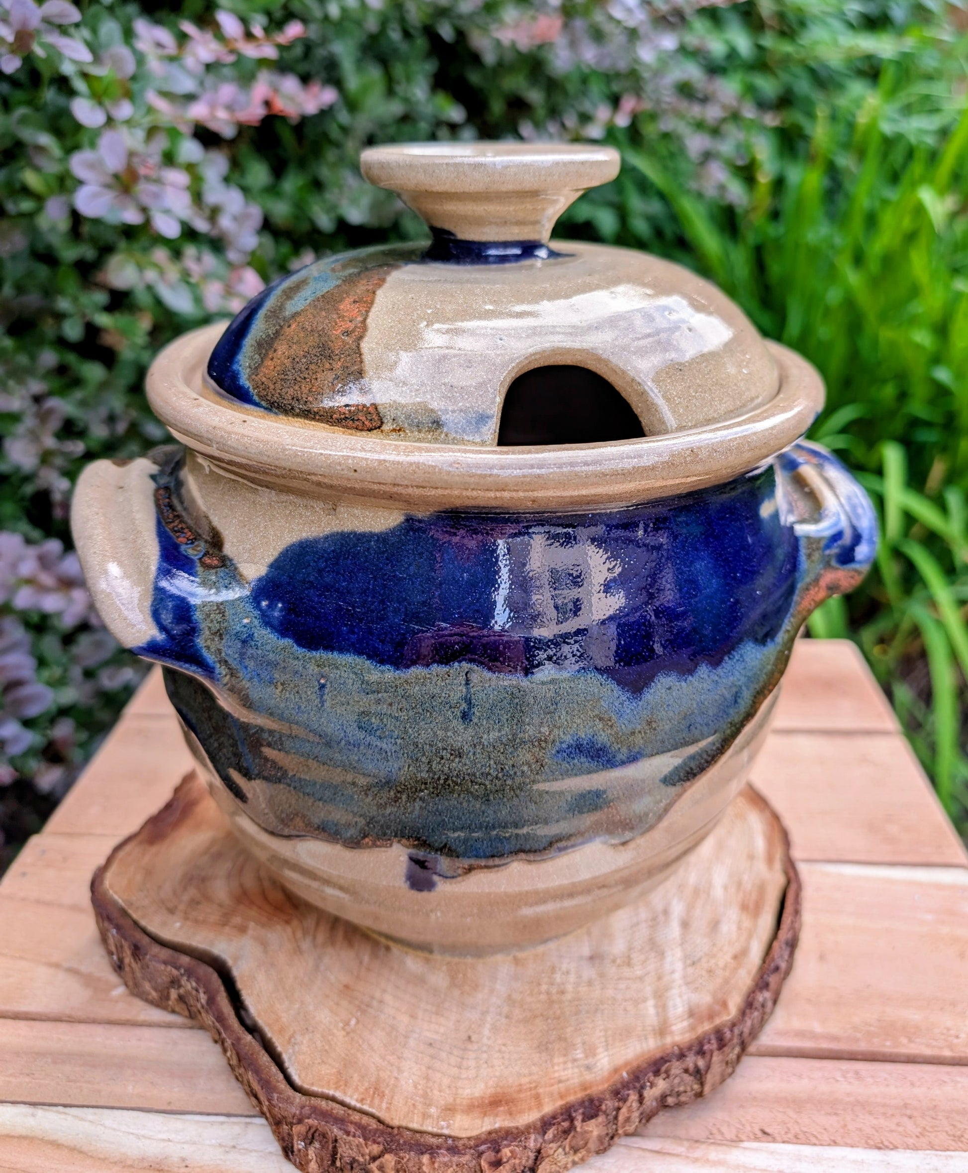 A beautifully handcrafted studio pottery tureen featuring a fitted lid, integrated handles, and a flowing cobalt blue glaze over warm oatmeal stoneware. Both functional and decorative, this artisan serving piece brings timeless craftsmanship and organic beauty to the table
