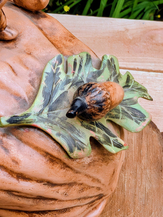 Celebrate the charm of 1970s woodland décor with this vintage Arnel's ceramic walnut-shaped covered dish featuring a beautifully hand-painted squirrel finial. Perfect as a decorative candy dish, seasonal accent, or rustic display piece for cottage and cabin-inspired interiors.