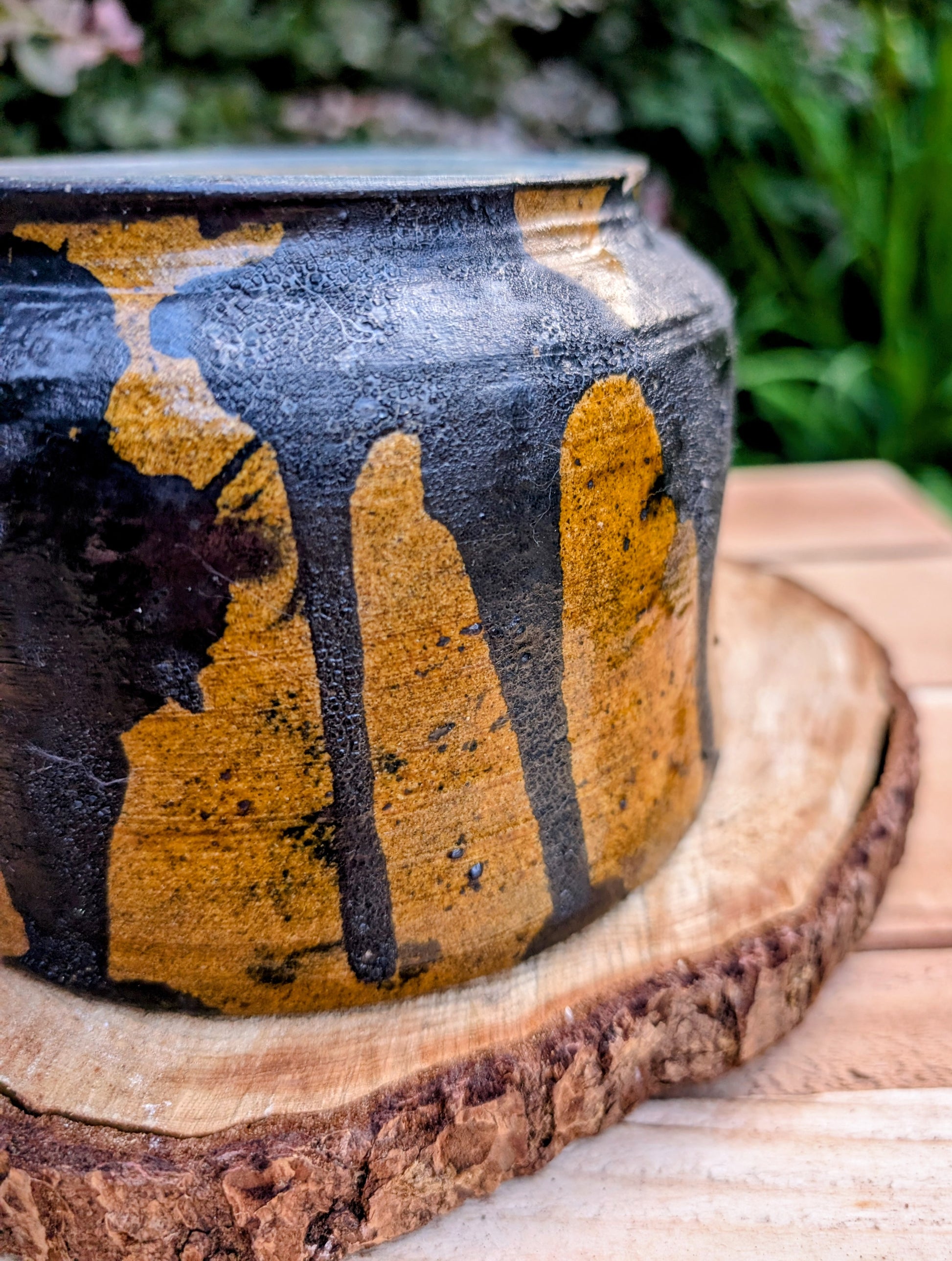 A beautifully hand-thrown studio pottery bowl featuring a rich cobalt blue interior, earthy ochre exterior, and expressive black drip glaze. Its timeless craftsmanship and organic design make it equally suited for serving, display, or adding artisan character to any Pacific Northwest-inspired home.
