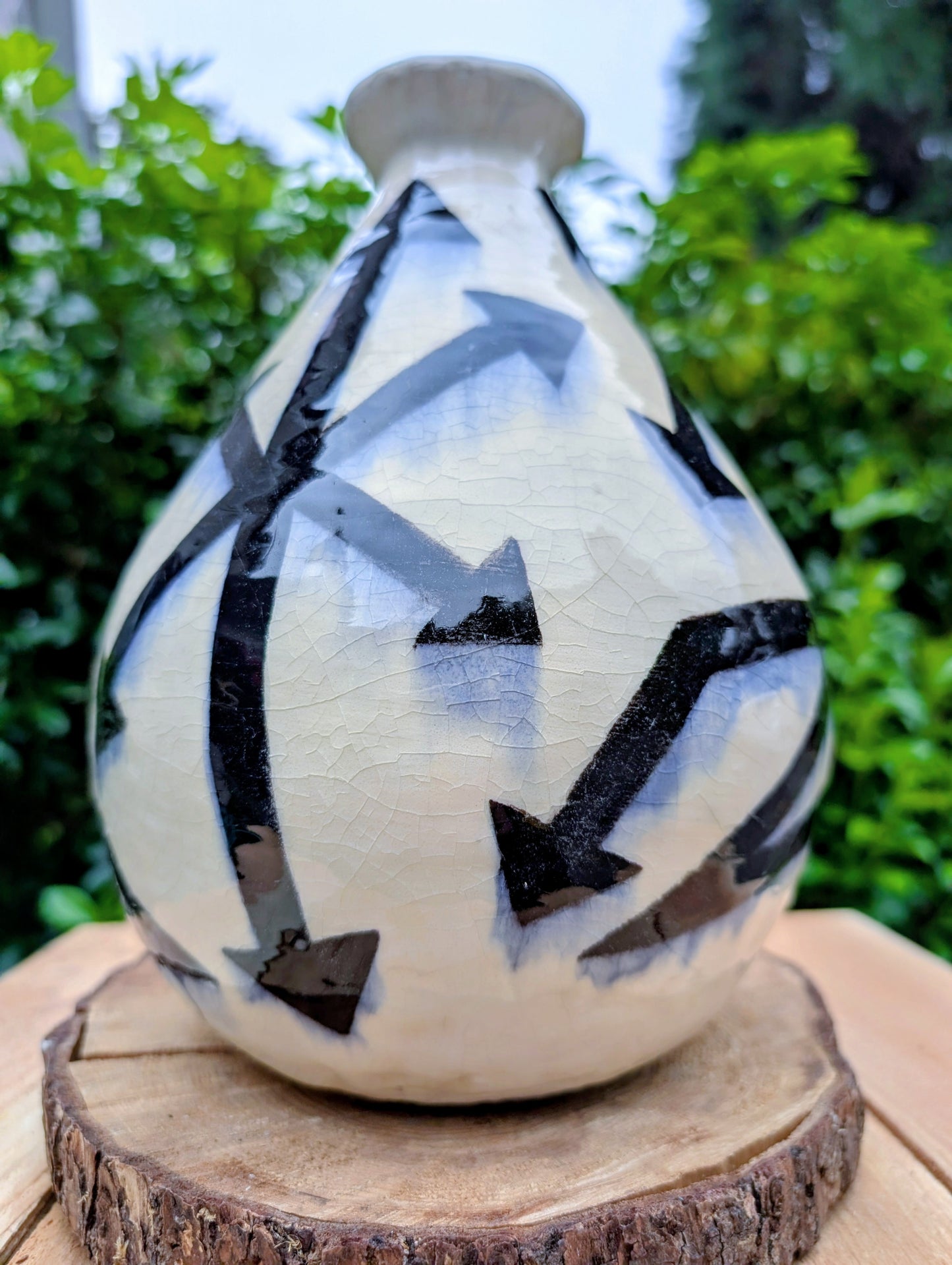 A striking signed studio pottery vase created by Sarah Palman in 1995, featuring bold black abstract arrow motifs over an ivory crackle glaze. This handcrafted ceramic sculpture blends modern design with timeless craftsmanship, making it equally beautiful displayed alone or with dried botanicals.