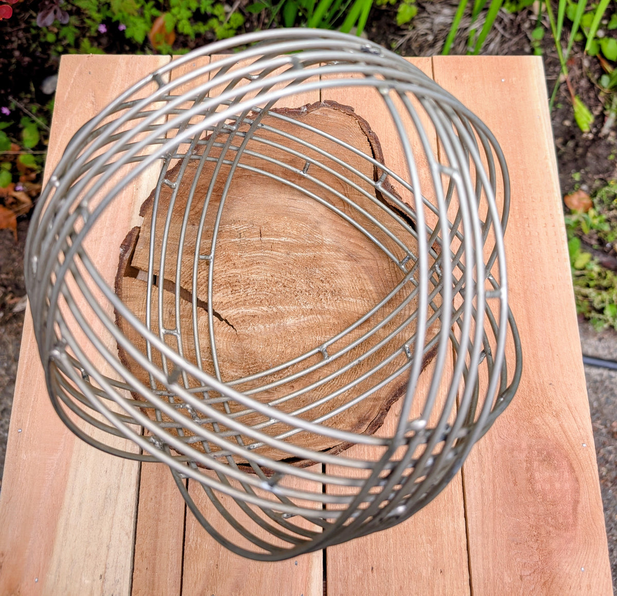Bring sculptural simplicity to your home or garden with this stainless steel wire sphere. Its clean geometric design adds year-round visual interest, whether displayed on a tabletop, nestled among plants, or styled as a modern garden accent.