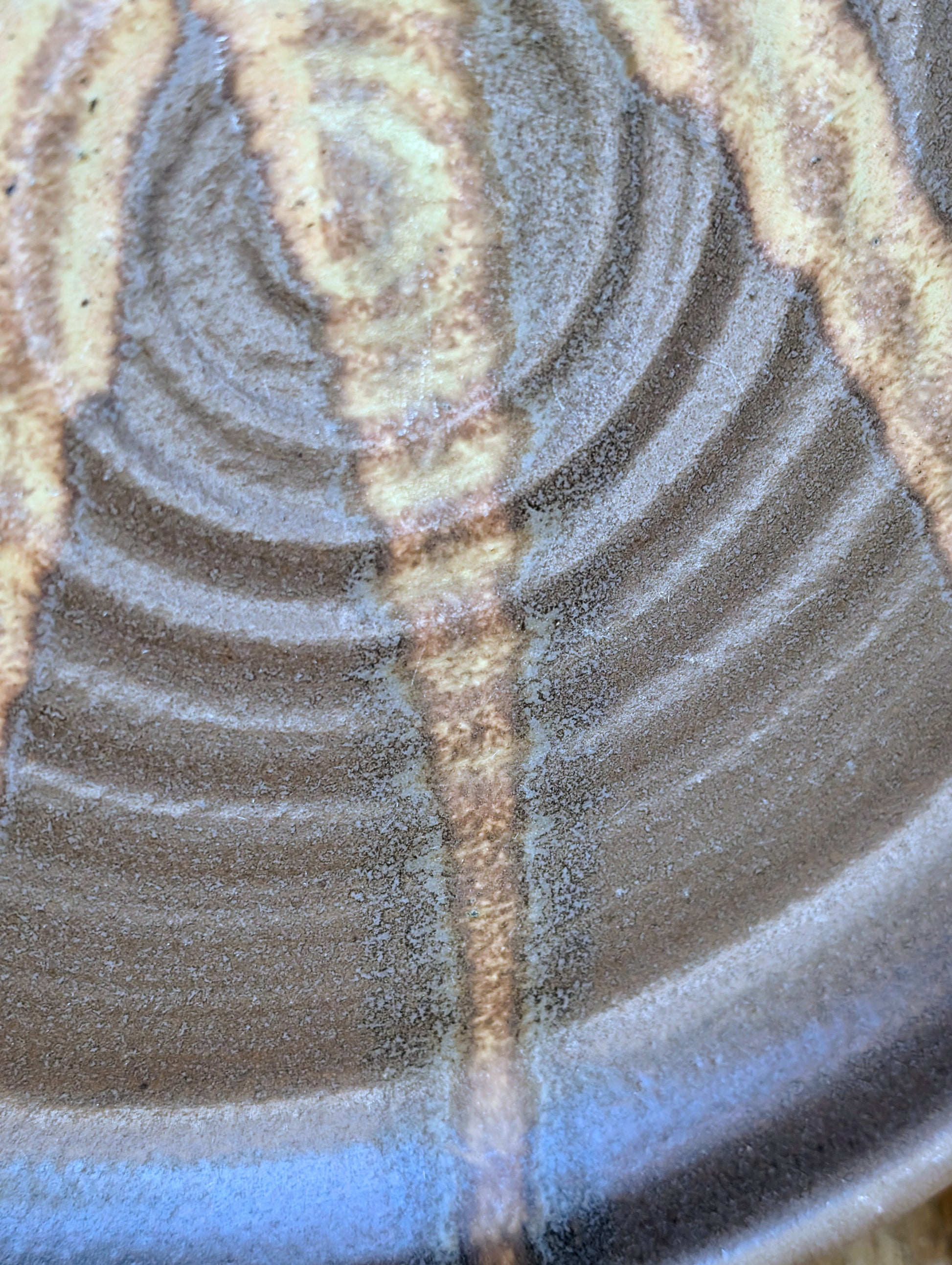 Celebrate the beauty of handmade craftsmanship with this one-of-a-kind studio pottery art plate featuring an expressive abstract octopus-inspired design. Rich earth-tone glazes and visible throwing rings make this versatile stoneware piece equally at home as functional serveware or coastal-inspired wall décor.