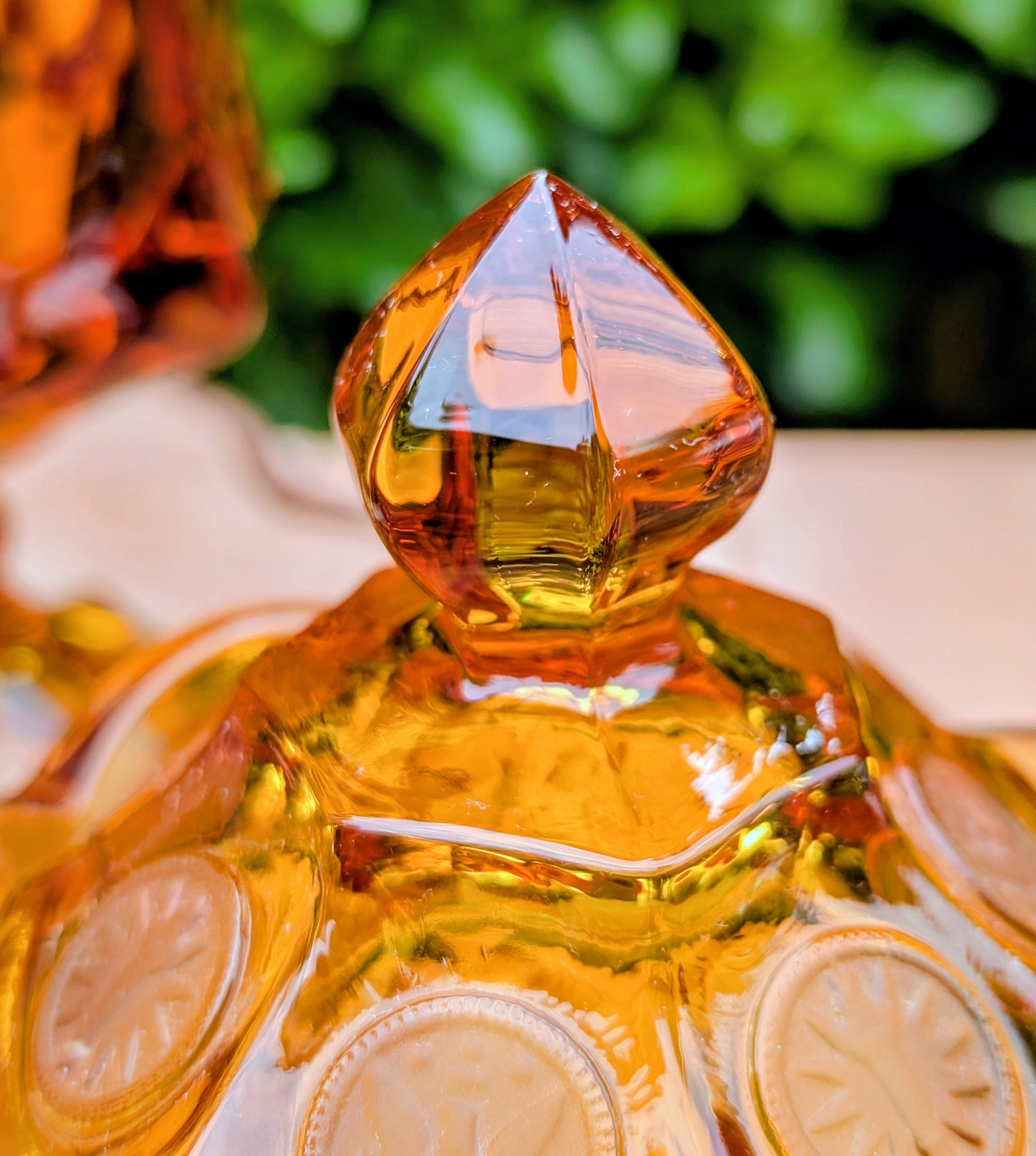 A stunning matching set of vintage Indiana Glass in the iconic Kings Crown (Coin) pattern. This coordinated amber glass collection includes a covered pedestal vase and matching covered candy dish, each with its original lid. A beautiful Mid-Century display for collectors and vintage home décor enthusiasts.