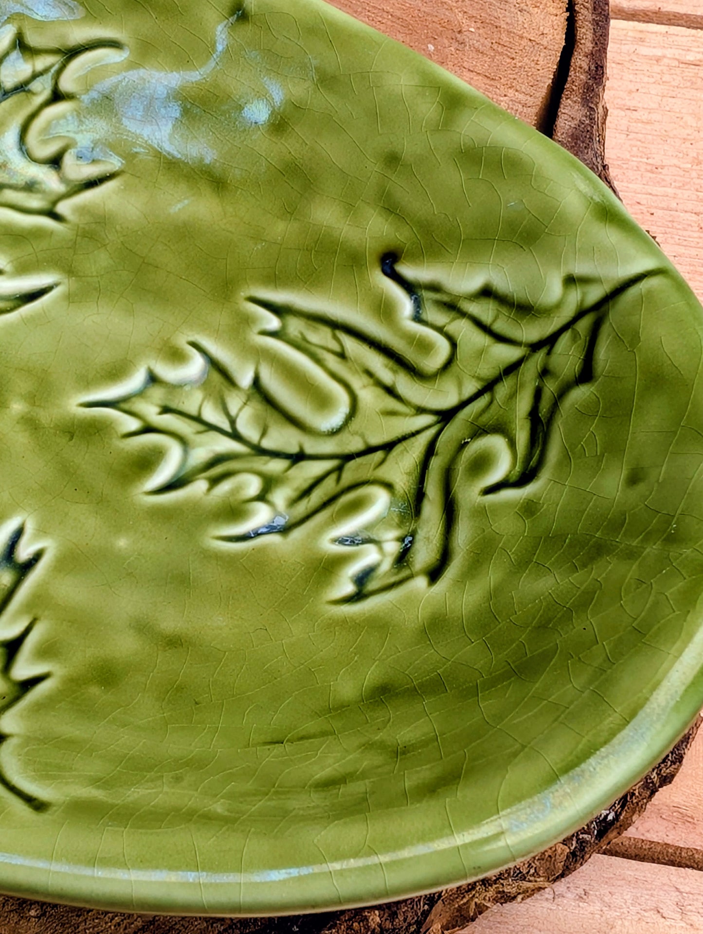Celebrate the beauty of the forest with this handcrafted embossed oak leaf ceramic dish. Featuring a rich olive-green glaze and an organic form, it's equally at home serving small bites, holding jewelry, or adding a touch of Pacific Northwest charm to your décor.