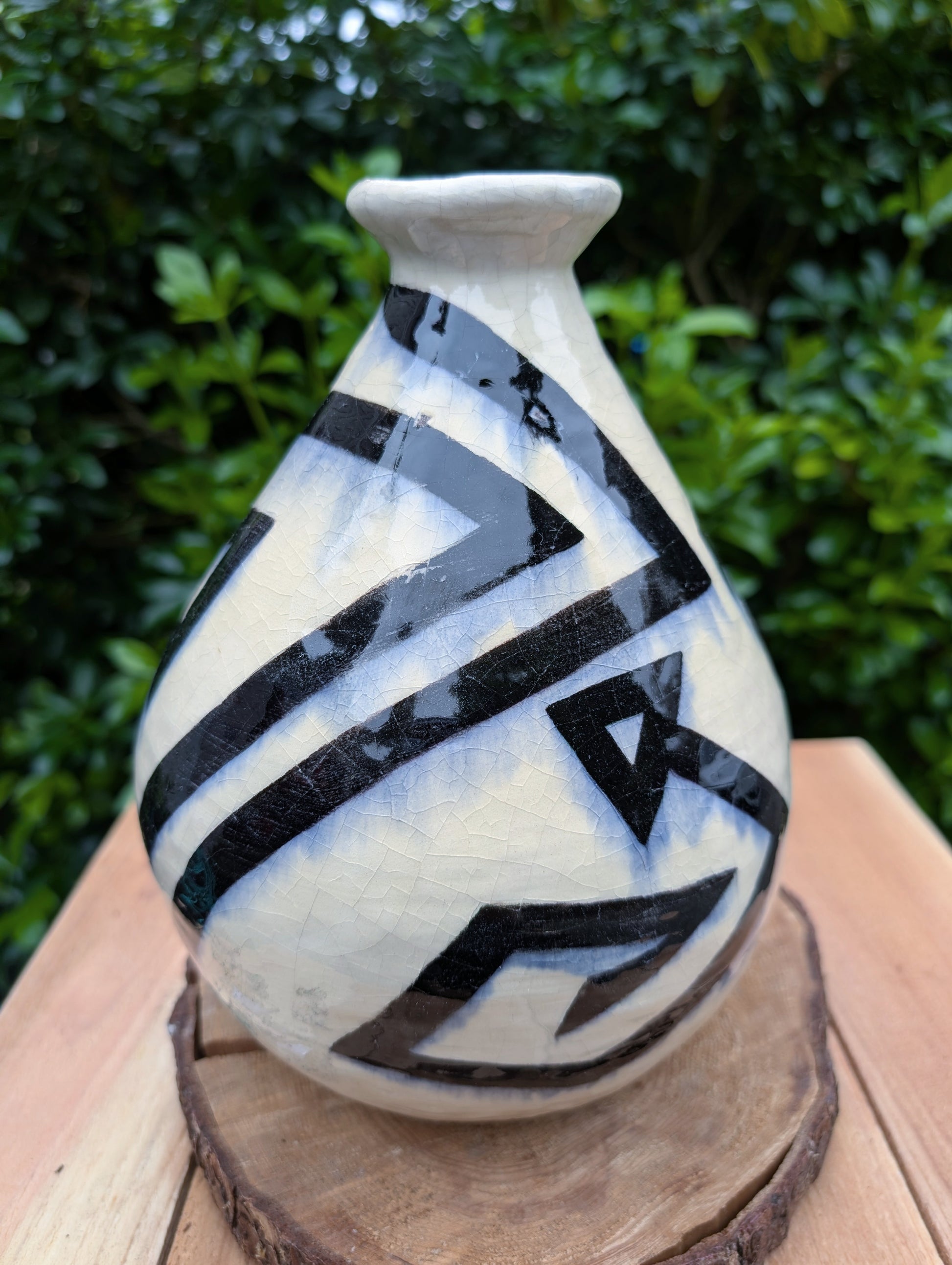 A striking signed studio pottery vase created by Sarah Palman in 1995, featuring bold black abstract arrow motifs over an ivory crackle glaze. This handcrafted ceramic sculpture blends modern design with timeless craftsmanship, making it equally beautiful displayed alone or with dried botanicals.