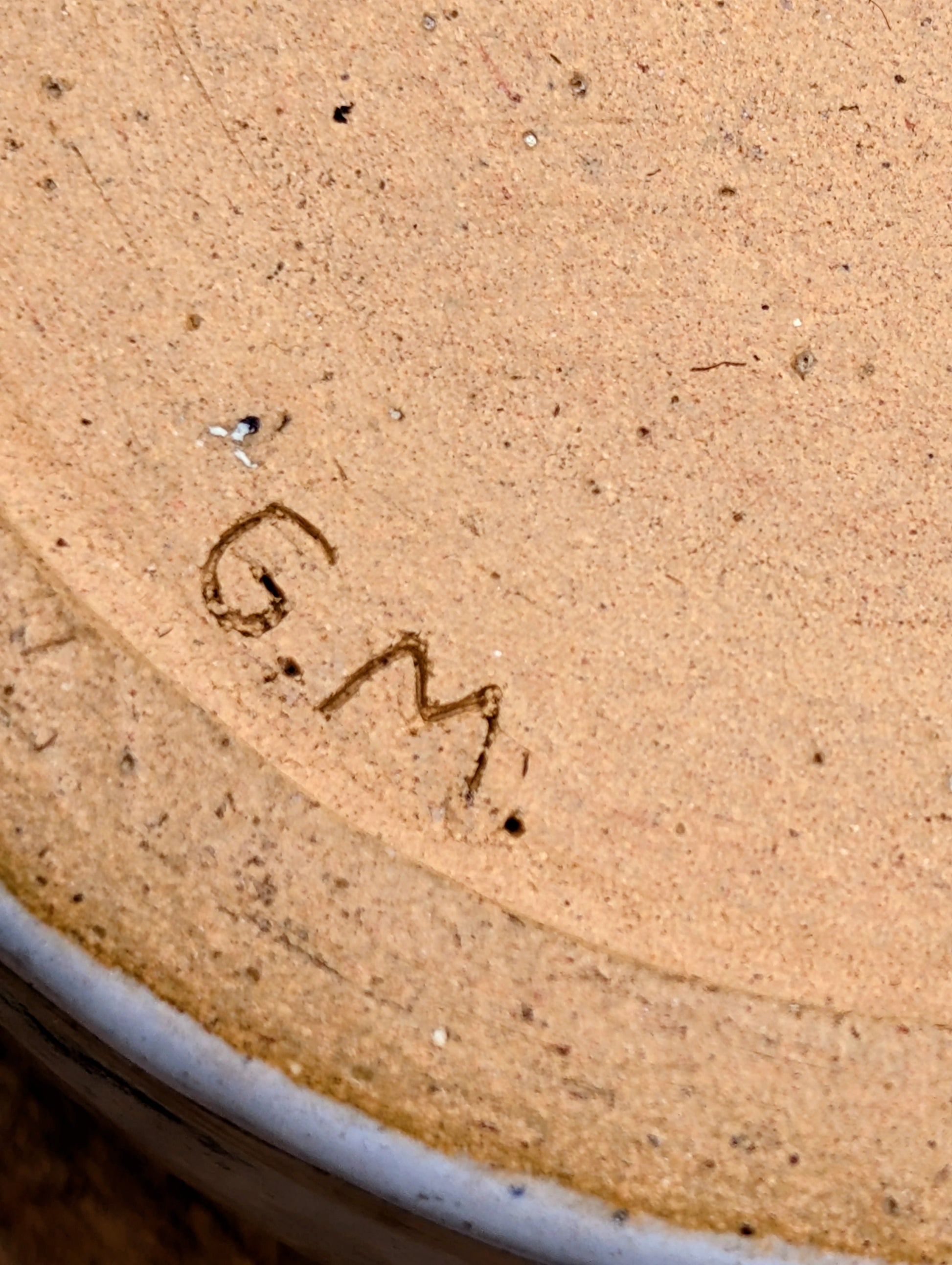 A beautifully hand-thrown studio pottery succulent planter featuring layered blue, moss green, and soft white glazes over high-fired stoneware. Complete with an integrated drainage hole and signed by the artist with the monogram "G.M.," this artisan planter brings handcrafted character to any home or garden.