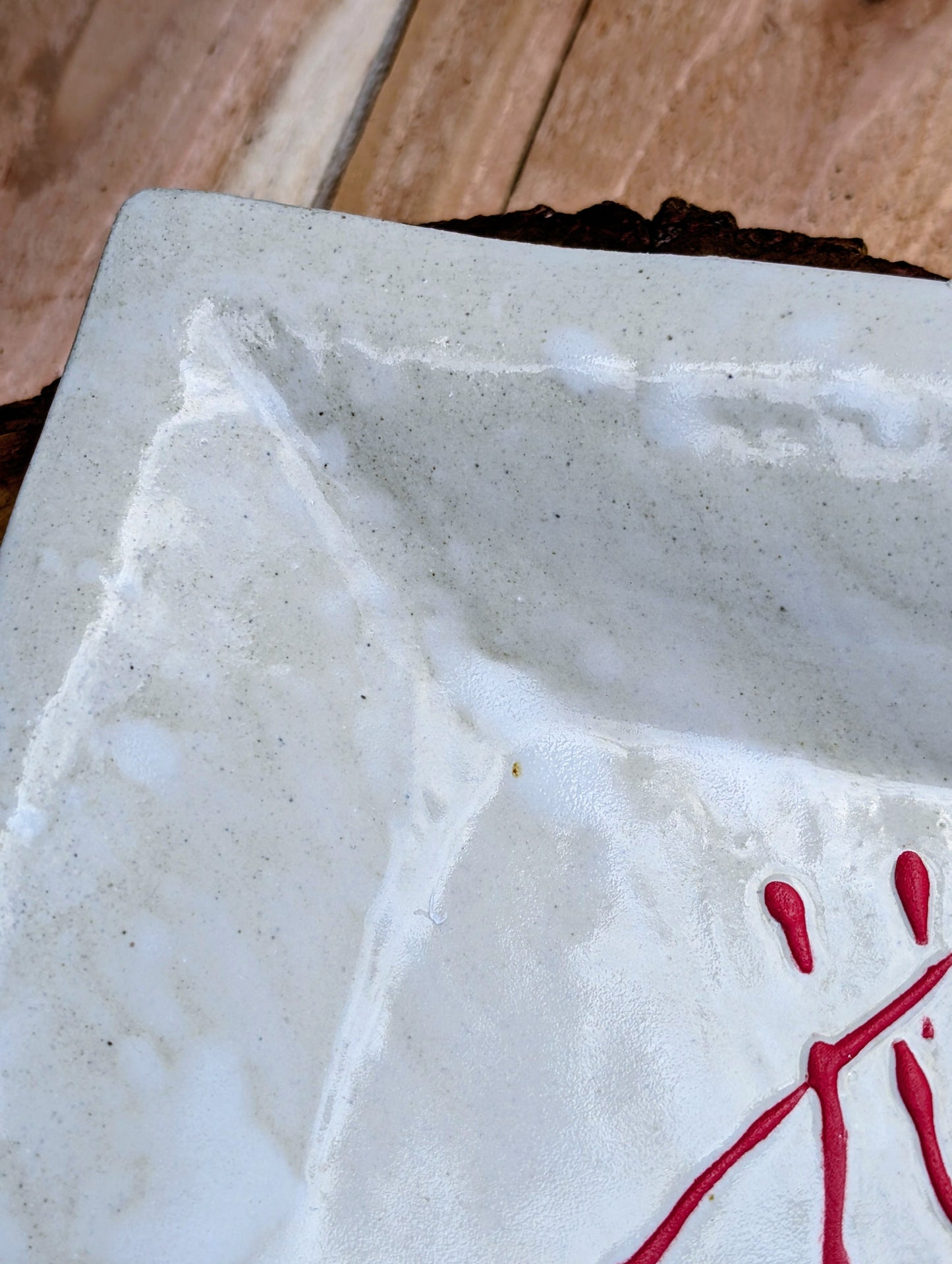 Bring handcrafted artistry into your home with this unsigned studio pottery catchall dish featuring a sculptural folded-corner design and expressive red slip decoration. Beautiful as both functional pottery and contemporary décor, it offers timeless Pacific Northwest style with organic modern appeal.