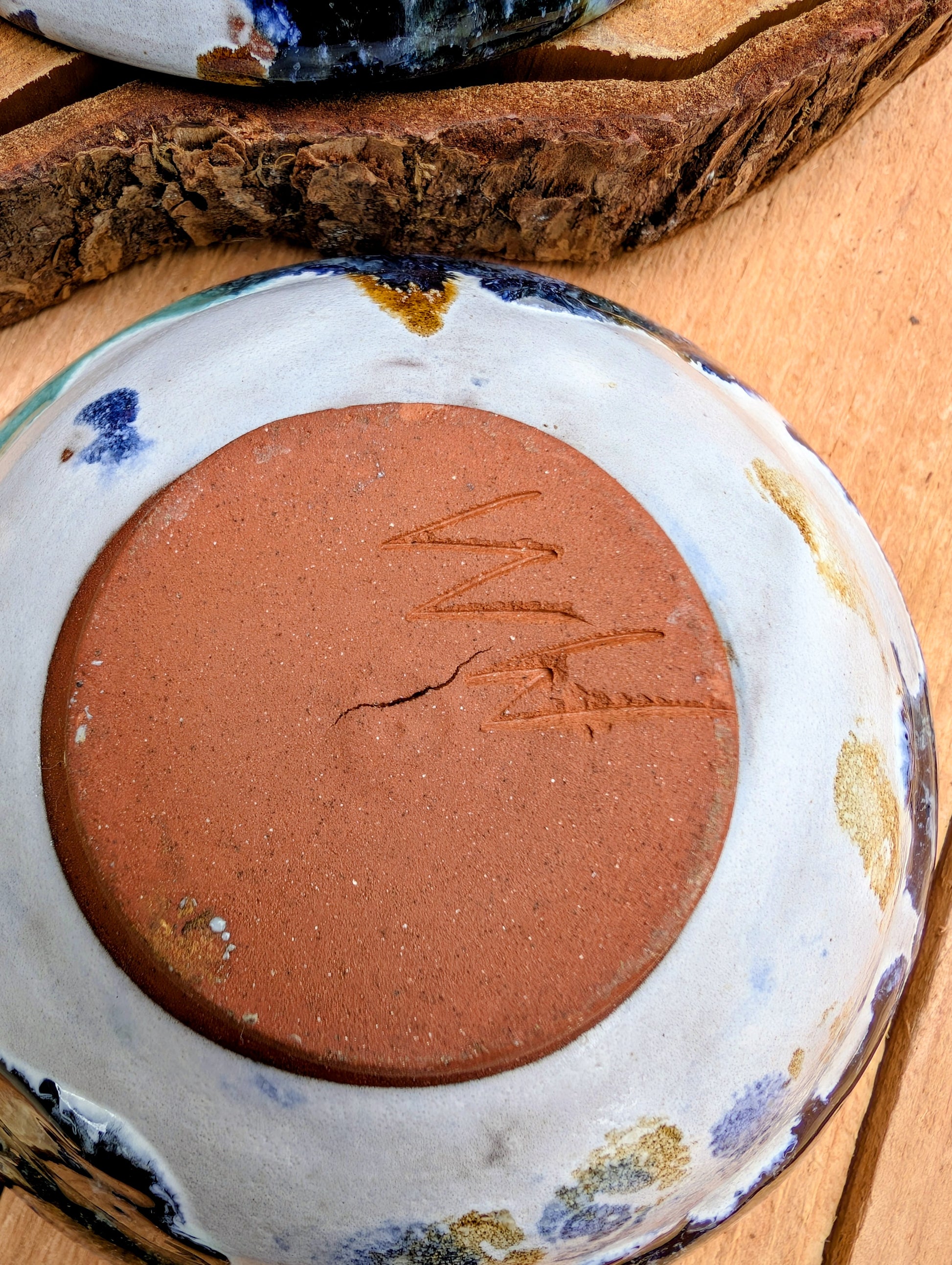 Bring handcrafted artistry to your table with this matching pair of signed studio pottery bowls. Finished with richly layered reactive glazes in cobalt blue, teal, amber, and ivory, these versatile artisan bowls are equally beautiful for entertaining or everyday display.