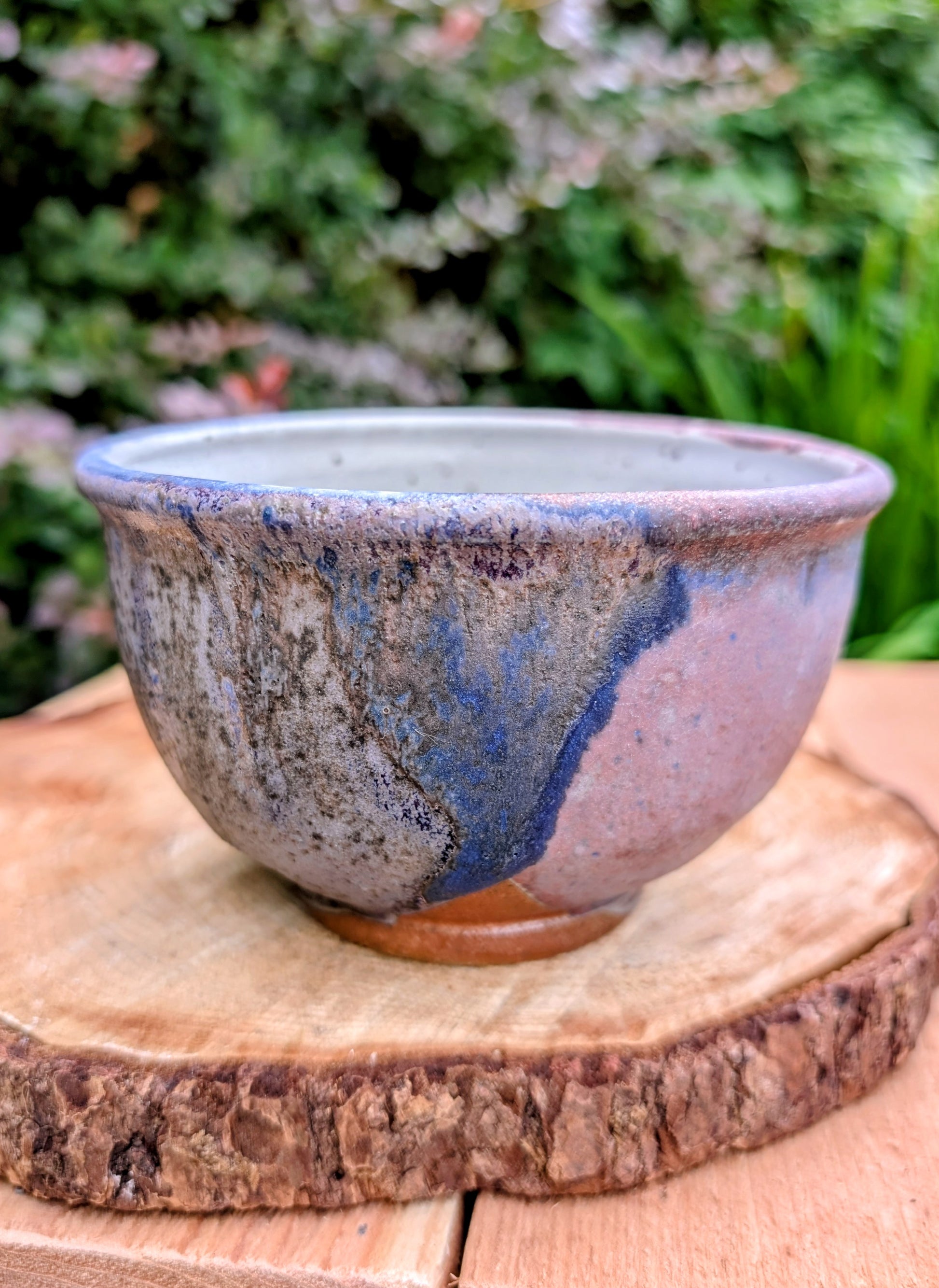 Bring handcrafted artistry to your home with this small footed studio pottery bowl featuring layered reactive glazes in purple, blue, charcoal, and earthy brown. Wheel-thrown from high-fired stoneware, its one-of-a-kind finish makes it equally beautiful as functional tableware or decorative art.