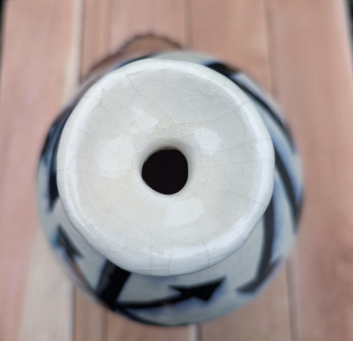 A striking signed studio pottery vase created by Sarah Palman in 1995, featuring bold black abstract arrow motifs over an ivory crackle glaze. This handcrafted ceramic sculpture blends modern design with timeless craftsmanship, making it equally beautiful displayed alone or with dried botanicals.
