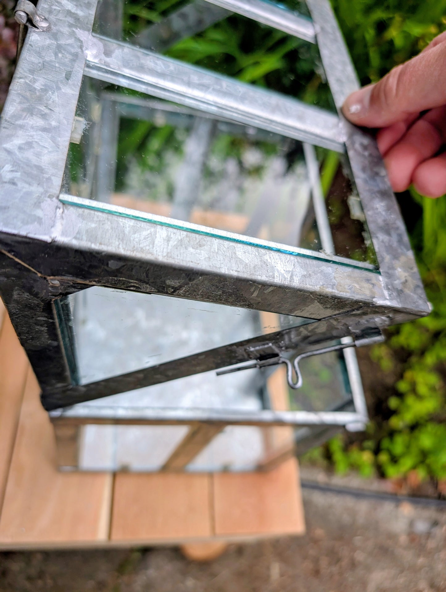 Bring the charm of a Victorian conservatory indoors with this decorative galvanized metal and glass tabletop greenhouse. Perfect for displaying succulents, moss gardens, candles, seasonal décor, or treasured collectibles, it adds timeless botanical style to any room.
